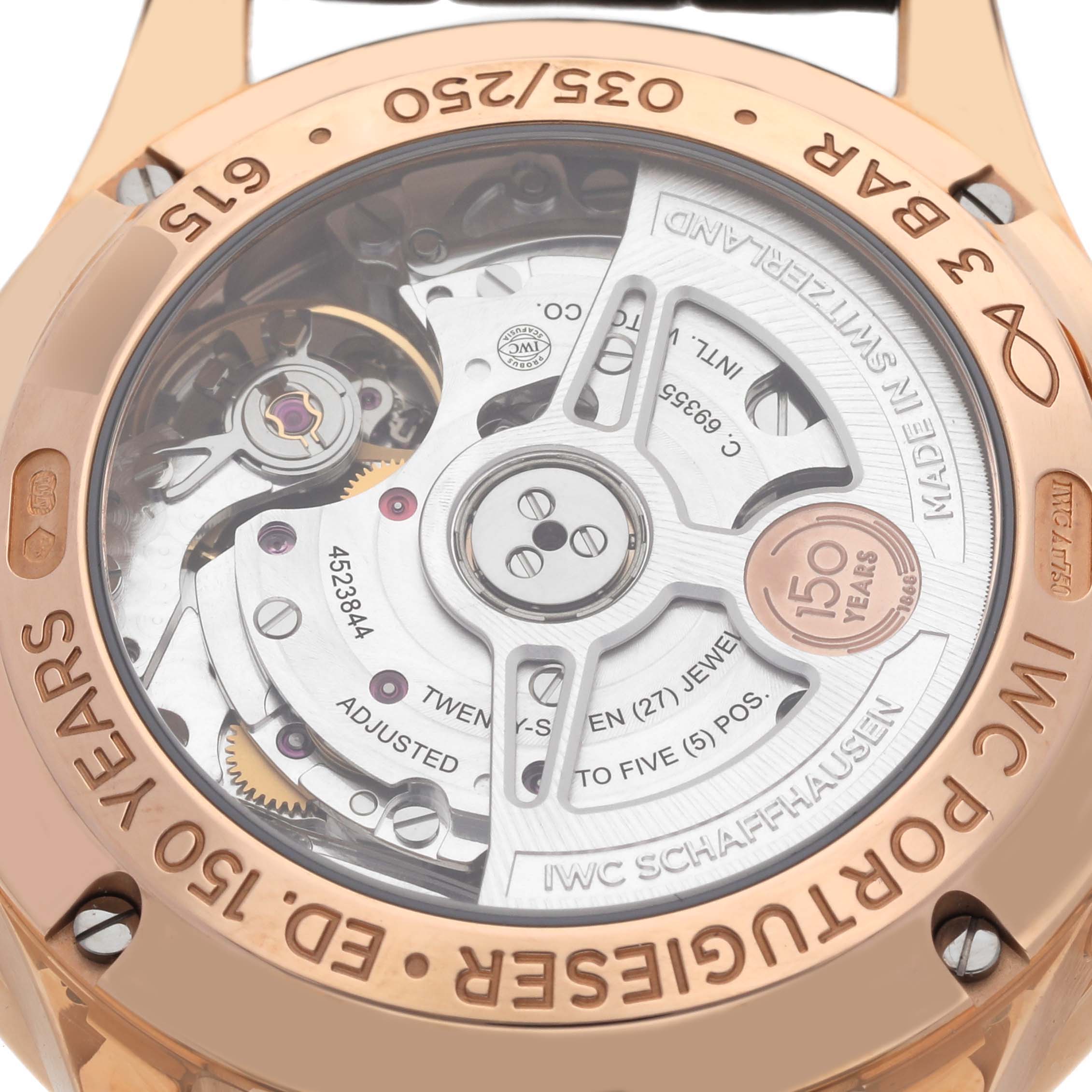 The image shows the back view of the IWC Portuguese IW371603 Men's Rose Gold White Dial IW371603 Men's Rose Gold White Dial model, highlighting its movement and case engravings.