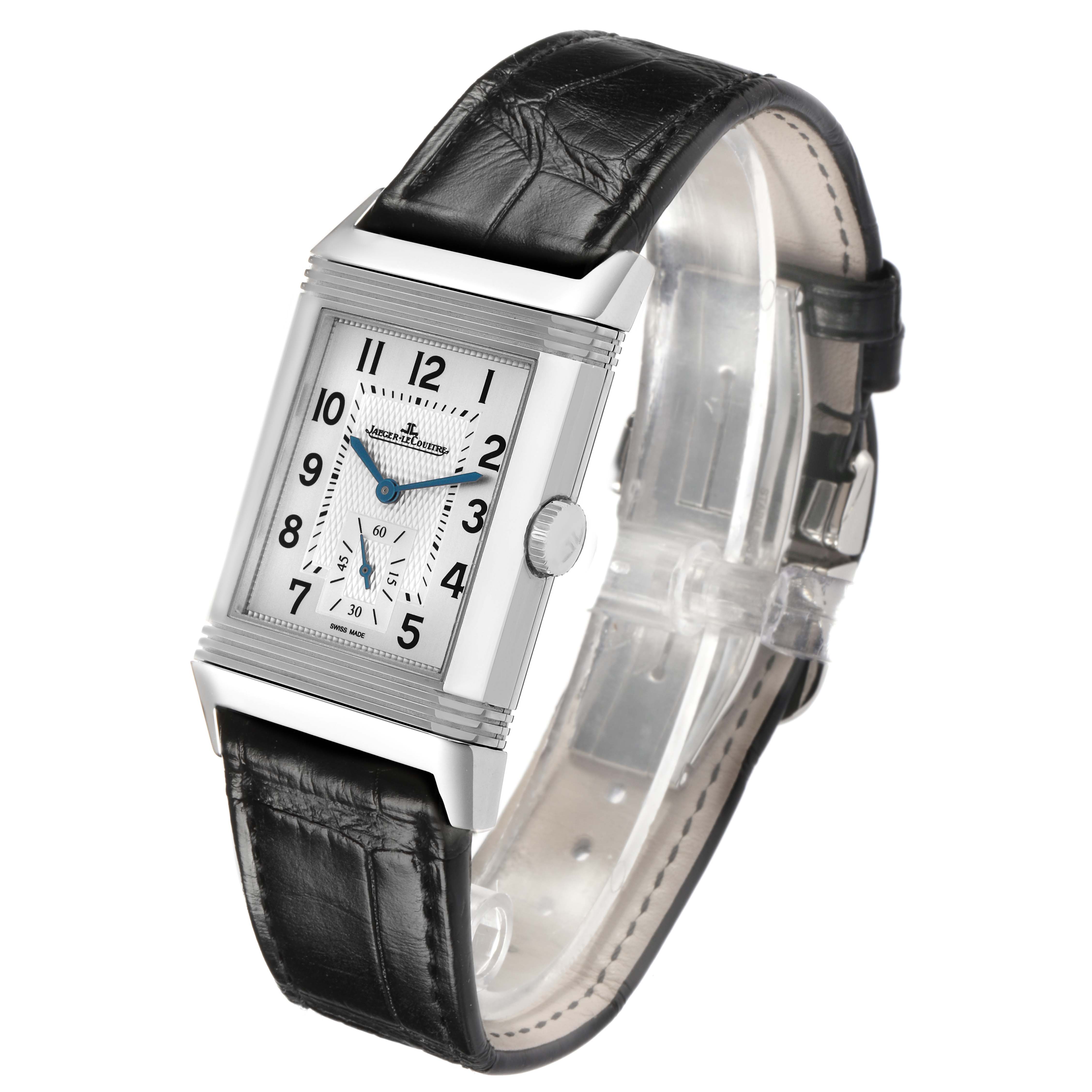 The Jaeger-LeCoultre Reverso watch is shown at an angled side view, highlighting the face, case, crown, and leather strap.