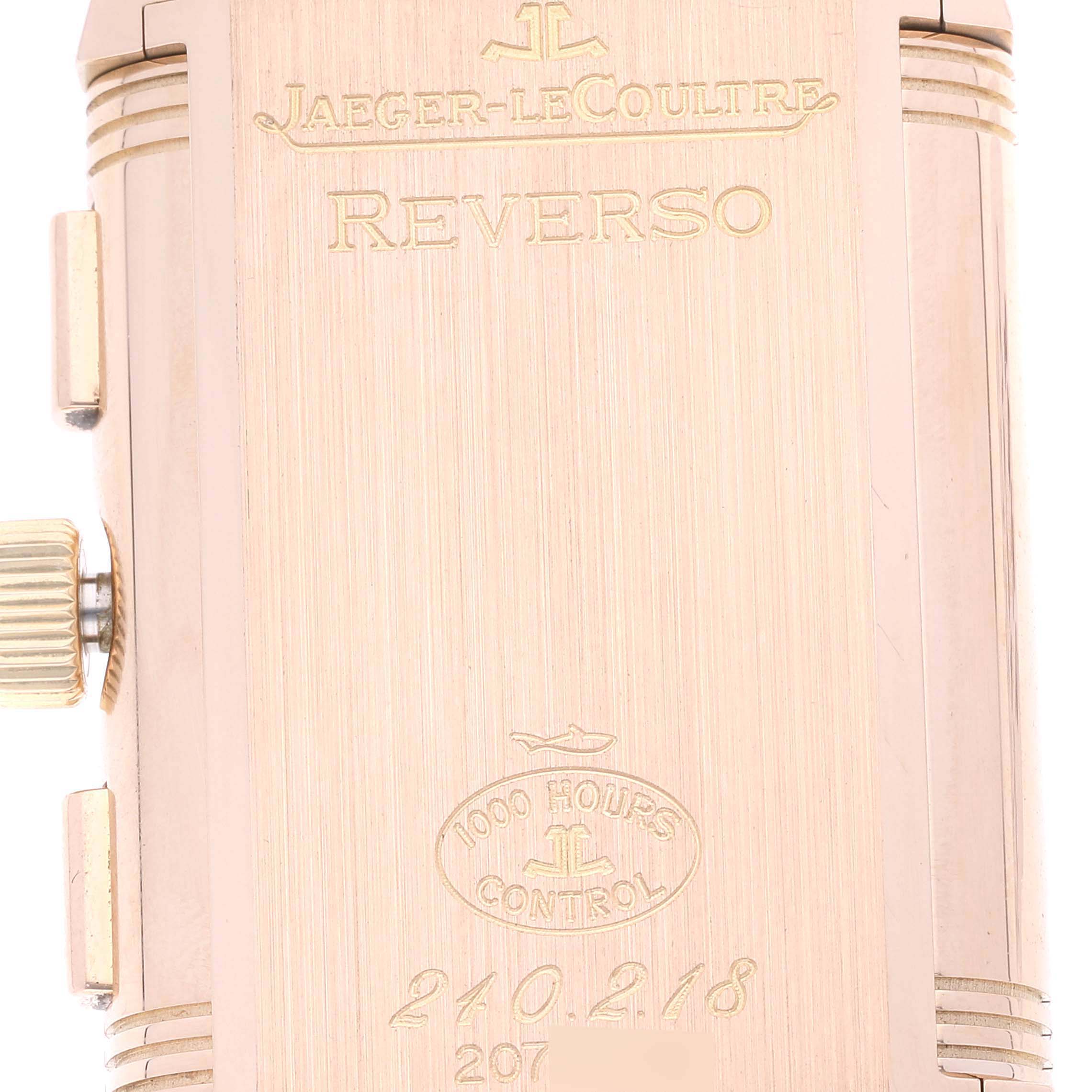 The image shows the back case of a Jaeger-LeCoultre Reverso watch, highlighting its engravings and crown.