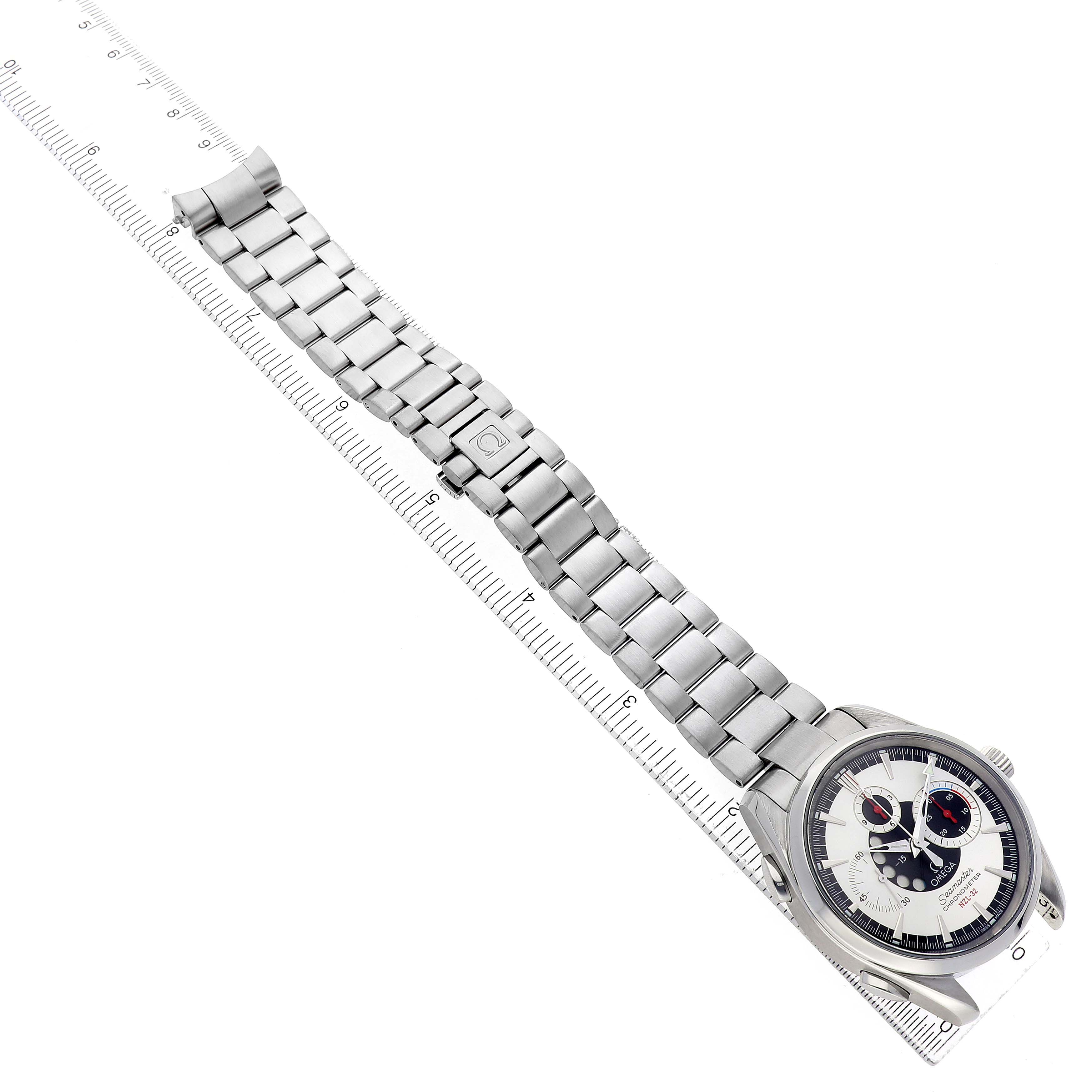 The Omega Aqua Terra 2513.30.00 Men's Stainless Steel Silver Dial watch is shown from a top view, highlighting its dial, stainless steel bracelet, and clasp alongside a ruler.