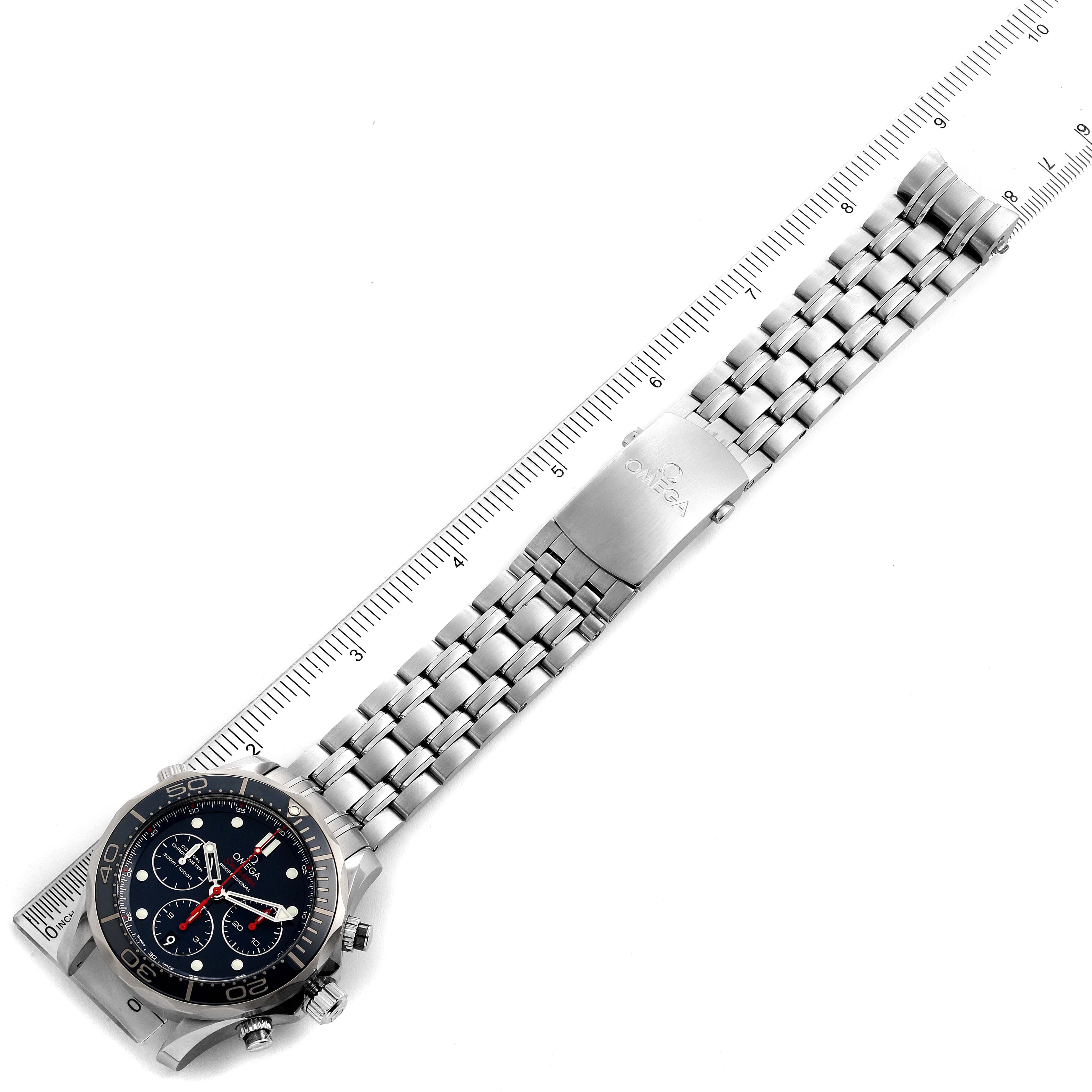 The image shows an overhead view of a Seamaster model watch by Omega, displaying the face, bezel, and full metal bracelet with a ruler.