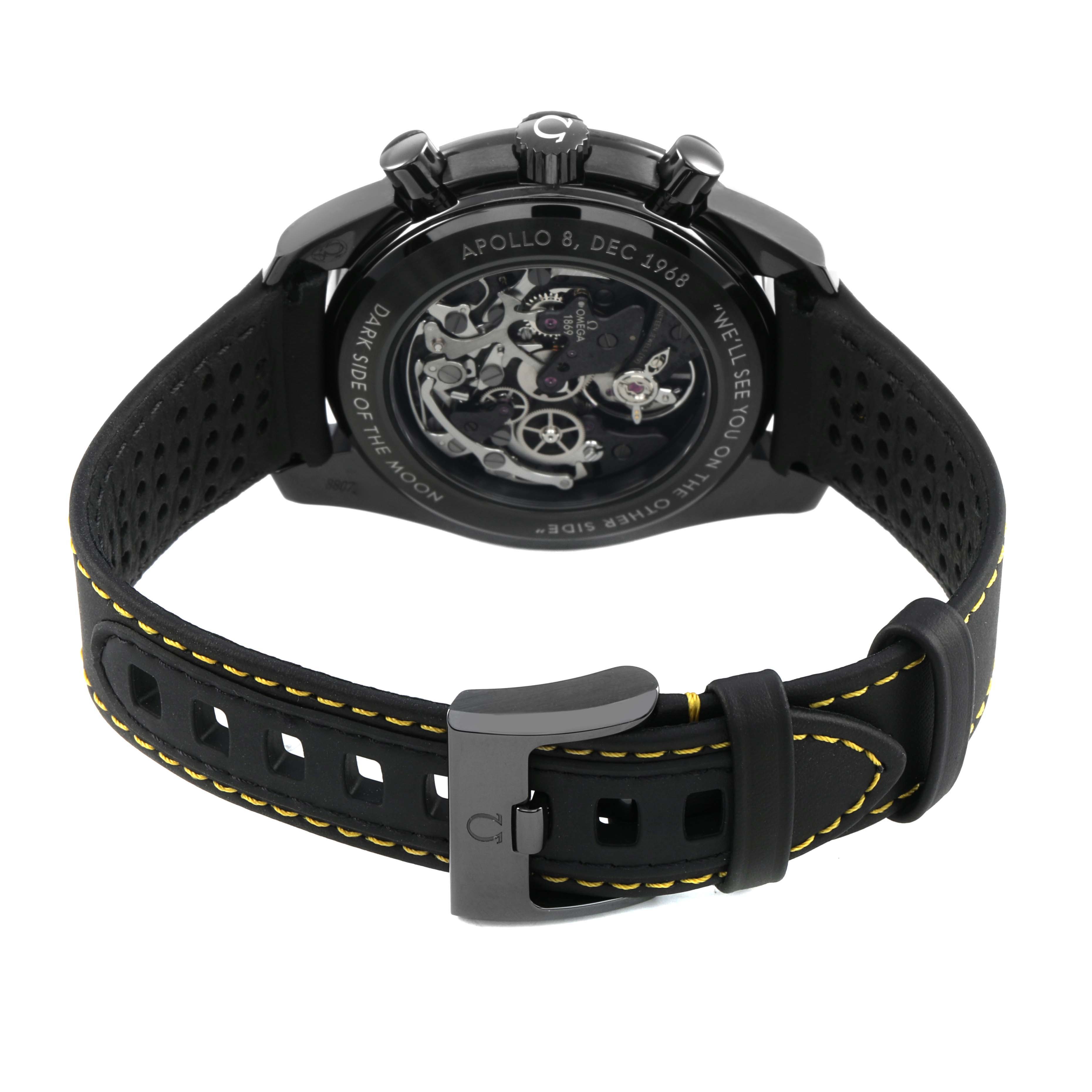 The Omega Speedmaster 311.92.44.30.01.001 Men's Ceramic Black Dial is shown from the back, highlighting its exposed movement and black strap with yellow stitching.