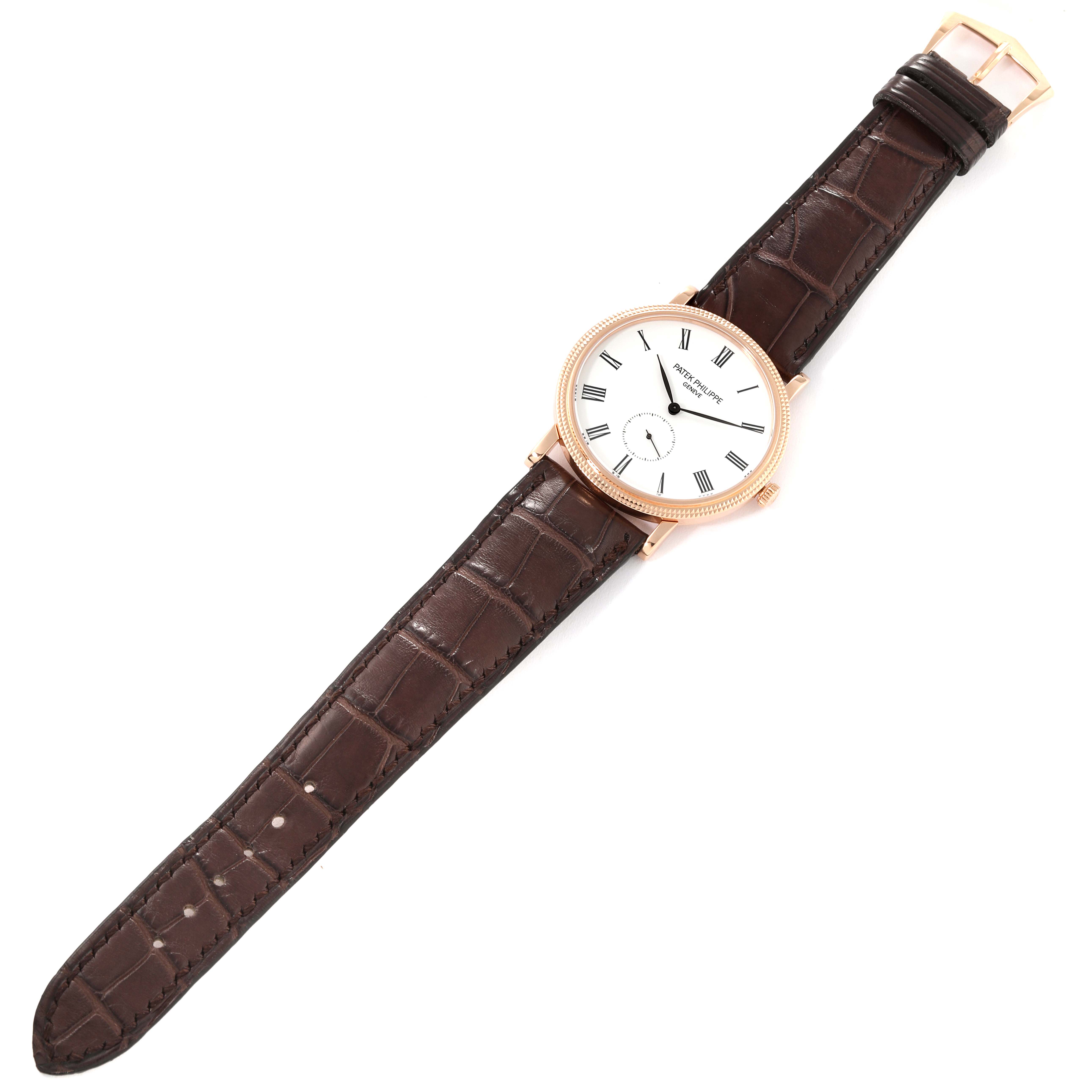 This image shows a top-down view of a Patek Philippe Calatrava 5116R-001 Men
s Rose Gold White Dial 5116R-001 Men
s Rose Gold White Dial watch, including the dial, case, and brown leather strap.
