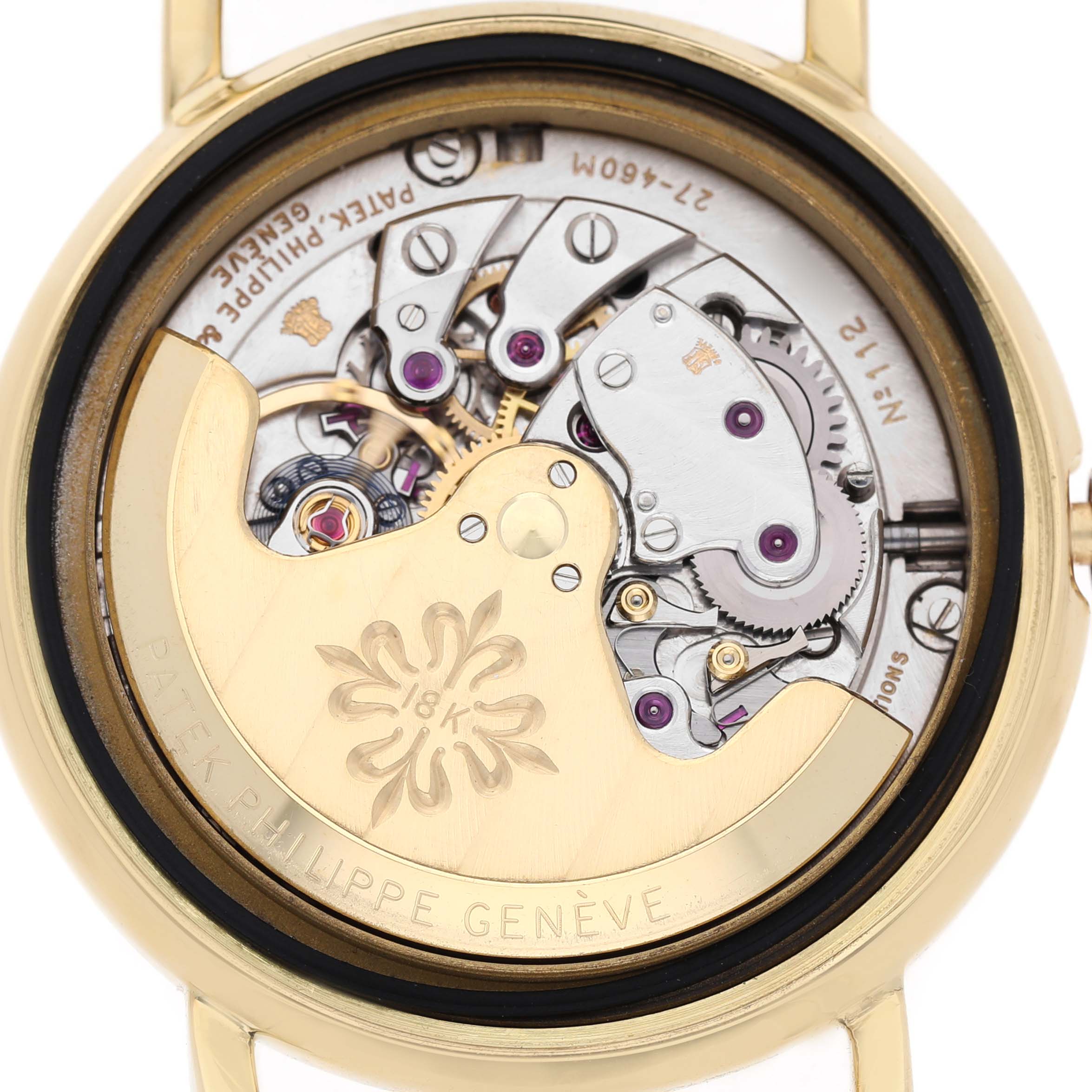 The image shows the movement of a Patek Philippe Calatrava 3445 Men's Yellow Gold Champagne Dial, focusing on the rotor and intricate internal mechanisms from the back.