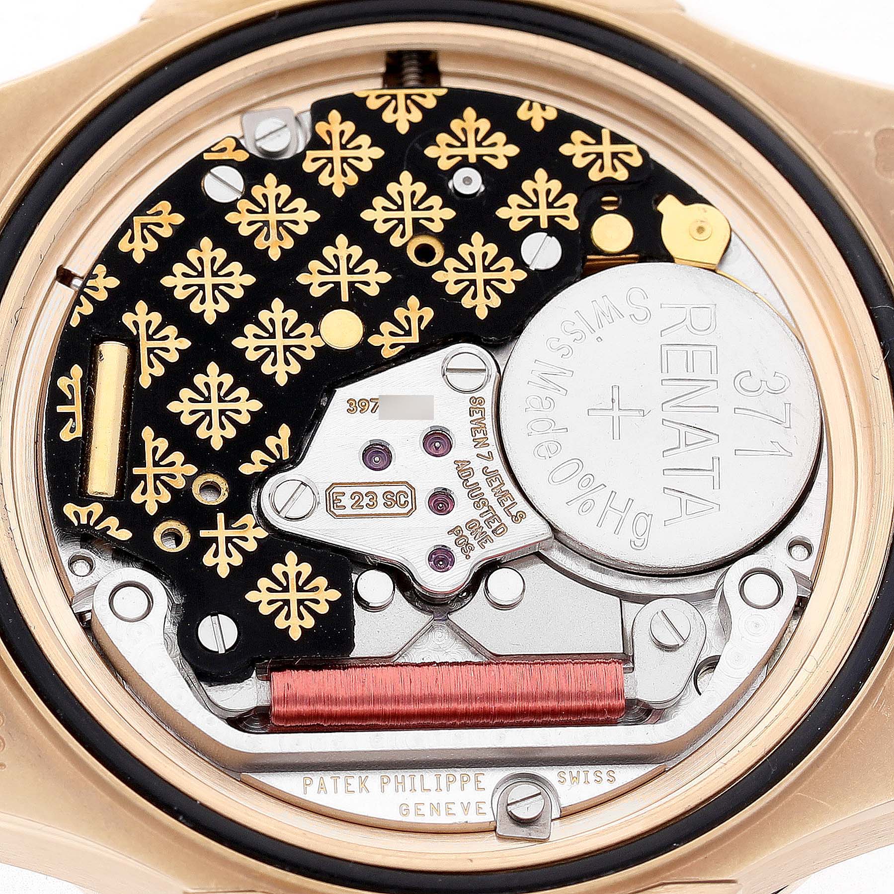 The image shows the back view of the Patek Philippe Nautilus 7010R Women's Rose Gold Silver Dial, focusing on its intricate movement and battery compartment.