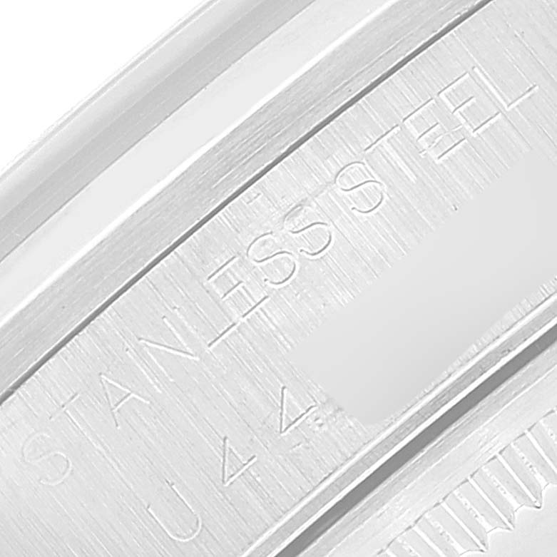 This close-up image shows the engraved text "STAINLESS STEEL" on the back casing of the Rolex Air-King 14000 Men's Stainless Steel Blue Dial 14000 Men's Stainless Steel Blue Dial watch.