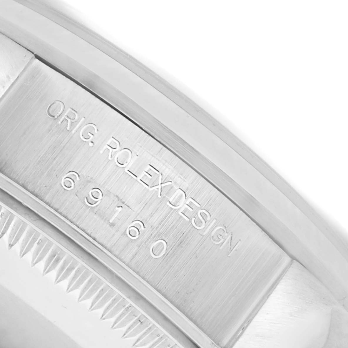 The image shows a close-up of the side and inner rim of a Rolex Date 69160 Women's Stainless Steel Blue Dial 69160 Women's Stainless Steel Blue Dial model, featuring the engraved design numbers.