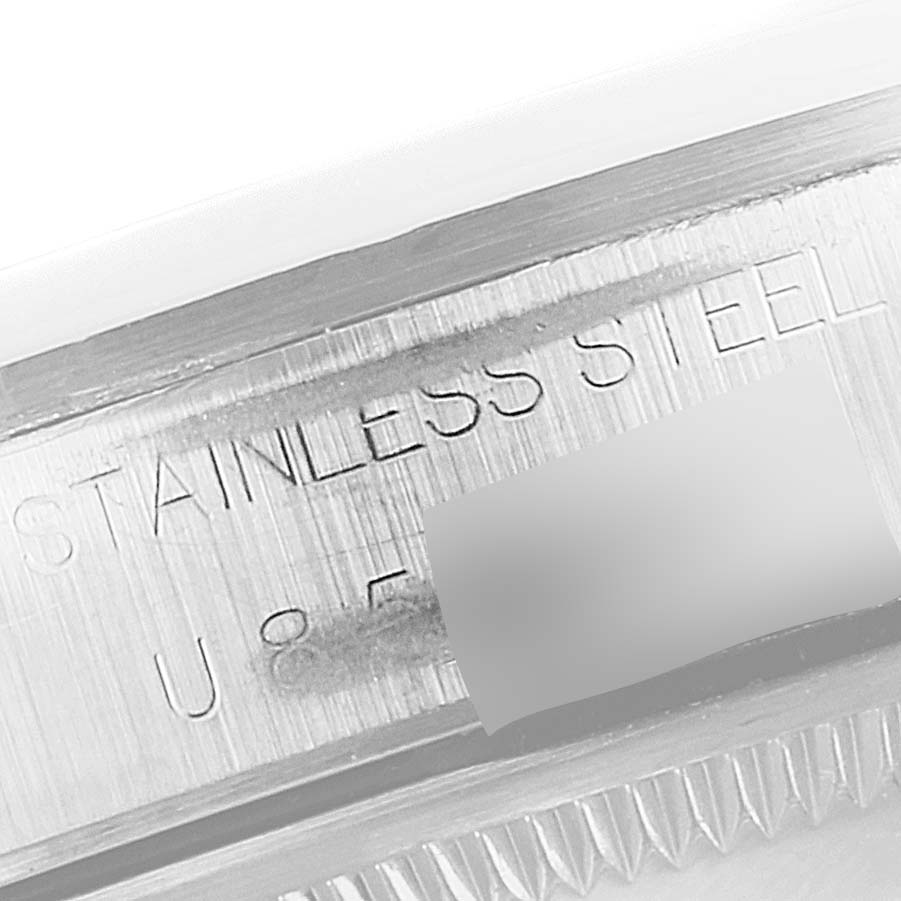 The image shows a close-up view of the serial number etching on a Rolex Date 15200 Men's Stainless Steel Silver Dial 15200 Men's Stainless Steel Silver Dial model stainless steel case.