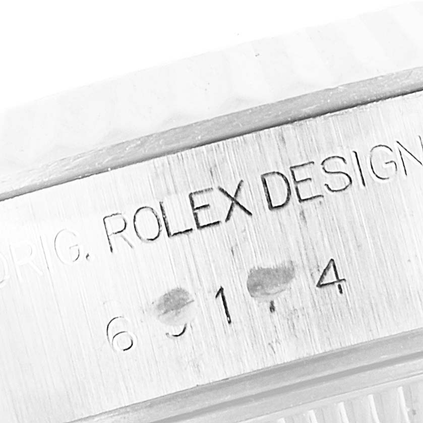 The image shows a close-up of the case side of a Rolex Datejust 69174 Women's Stainless Steel Silver Dial 69174 Women's Stainless Steel Silver Dial, featuring the "ROLEX DESIGN" engraving and model number.