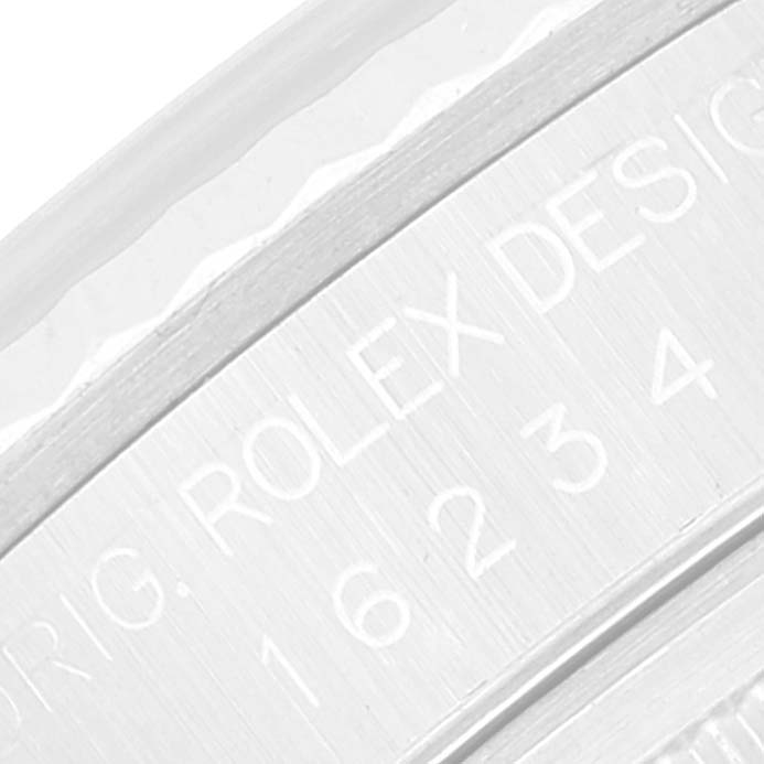 The image shows an extreme close-up of the engraved model numbers on the side of the bezel of a Rolex Datejust 16234 Men's Stainless Steel Silver Dial 16234 Men's Stainless Steel Silver Dial watch.