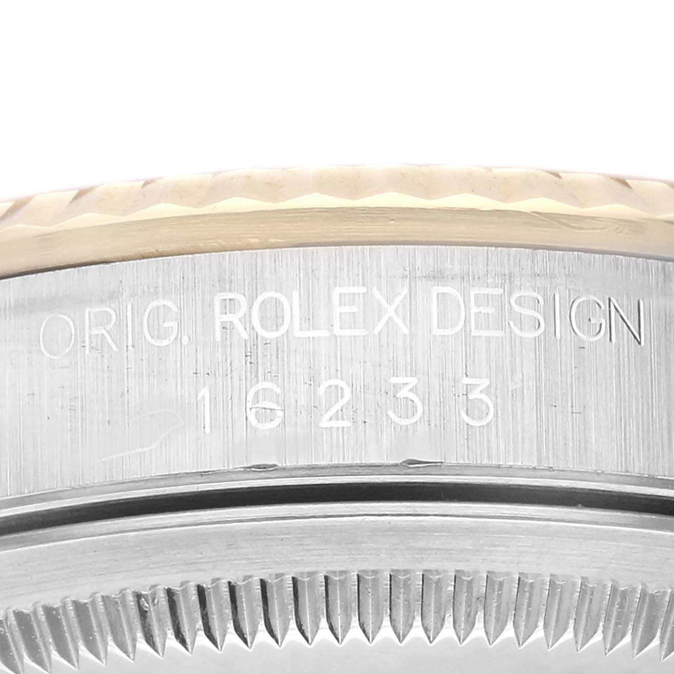 This image shows an angled close-up of the serial number and part of the bezel of a Rolex Datejust 16233 Men's Steel and Gold (two tone) Champagne Dial 16233 Men's Steel and Gold (two tone) Champagne Dial watch.