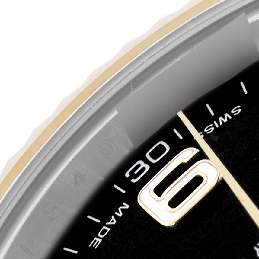 The image shows a close-up of the Rolex Datejust 41 116333 Men's Steel and Gold (two tone) Black Dial 116333 Men's Steel and Gold (two tone) Black Dial watch's dial, highlighting the hour markers and part of the bezel.