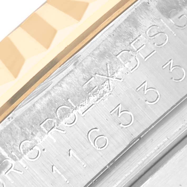 The image shows a close-up of the side of a Rolex Datejust 41 116333 Men's Steel and Gold (two tone) Black Dial 116333 Men's Steel and Gold (two tone) Black Dial, highlighting engraved serial numbers and part of the bezel.