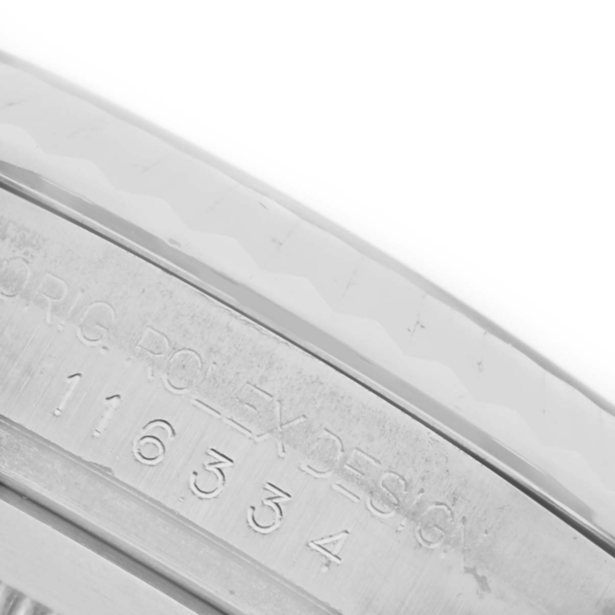 The image shows a close-up of the engraved side of the Rolex Datejust 41 116334 Men's Stainless Steel White Dial 116334 Men's Stainless Steel White Dial bezel.
