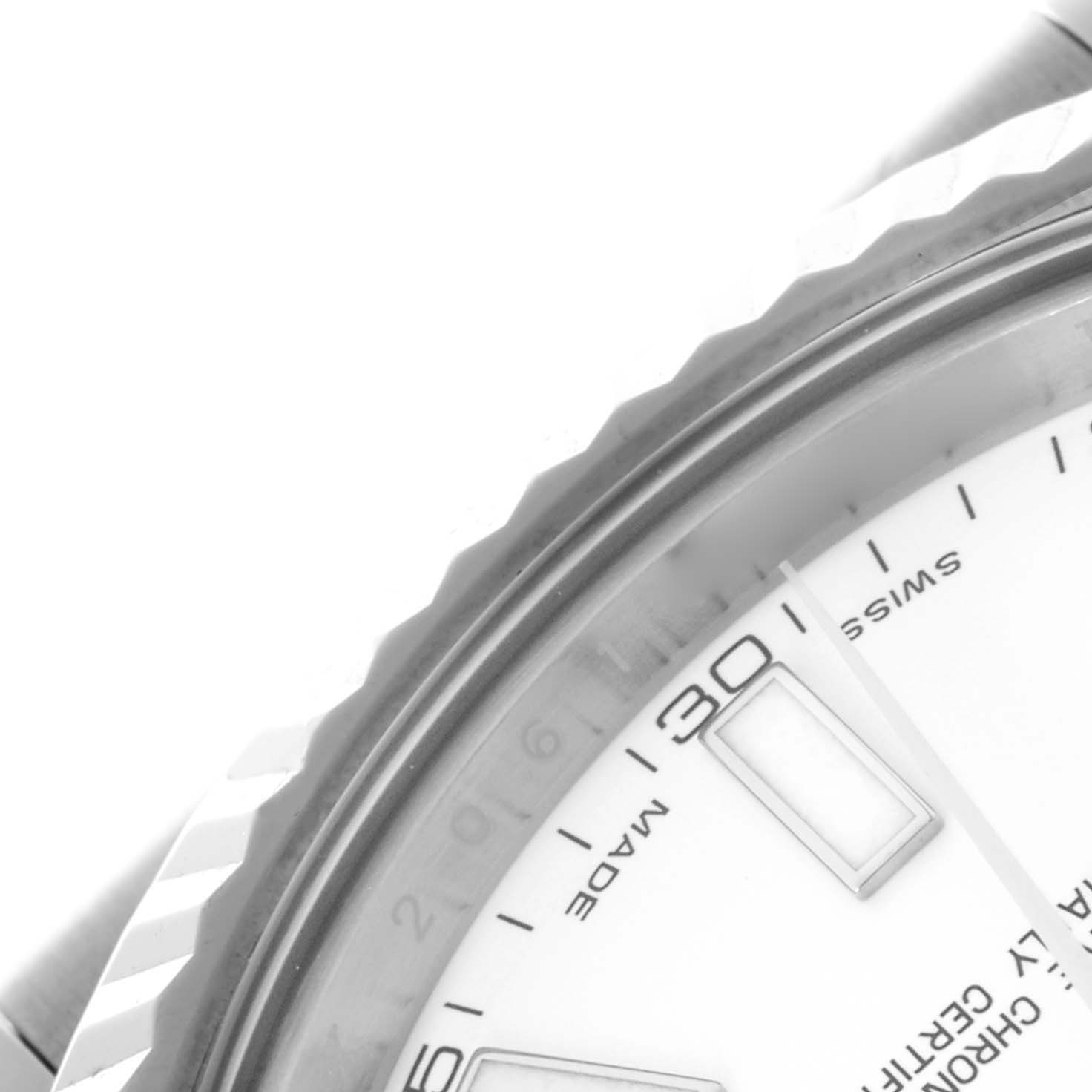 The image shows a close-up of the Rolex Datejust 41 116334 Men's Stainless Steel White Dial 116334 Men's Stainless Steel White Dial, highlighting the bezel, part of the dial, and the date display.