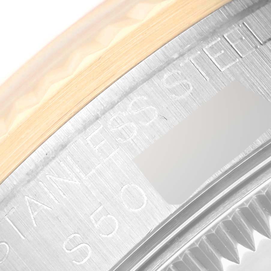 This close-up image of a Rolex Mid-Size 68273 Women
s Steel and Gold (two tone) Mother of Pearl Dial 68273 Women
s Steel and Gold (two tone) Mother of Pearl Dial model shows part of the engraved stainless steel casing and edge of the bezel.