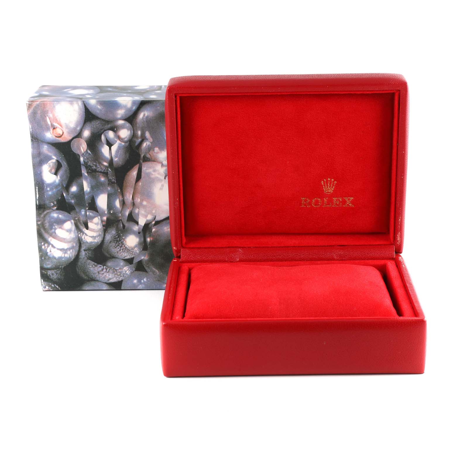 This image shows a red Rolex watch box, open to reveal the interior, with an outer box in the background.