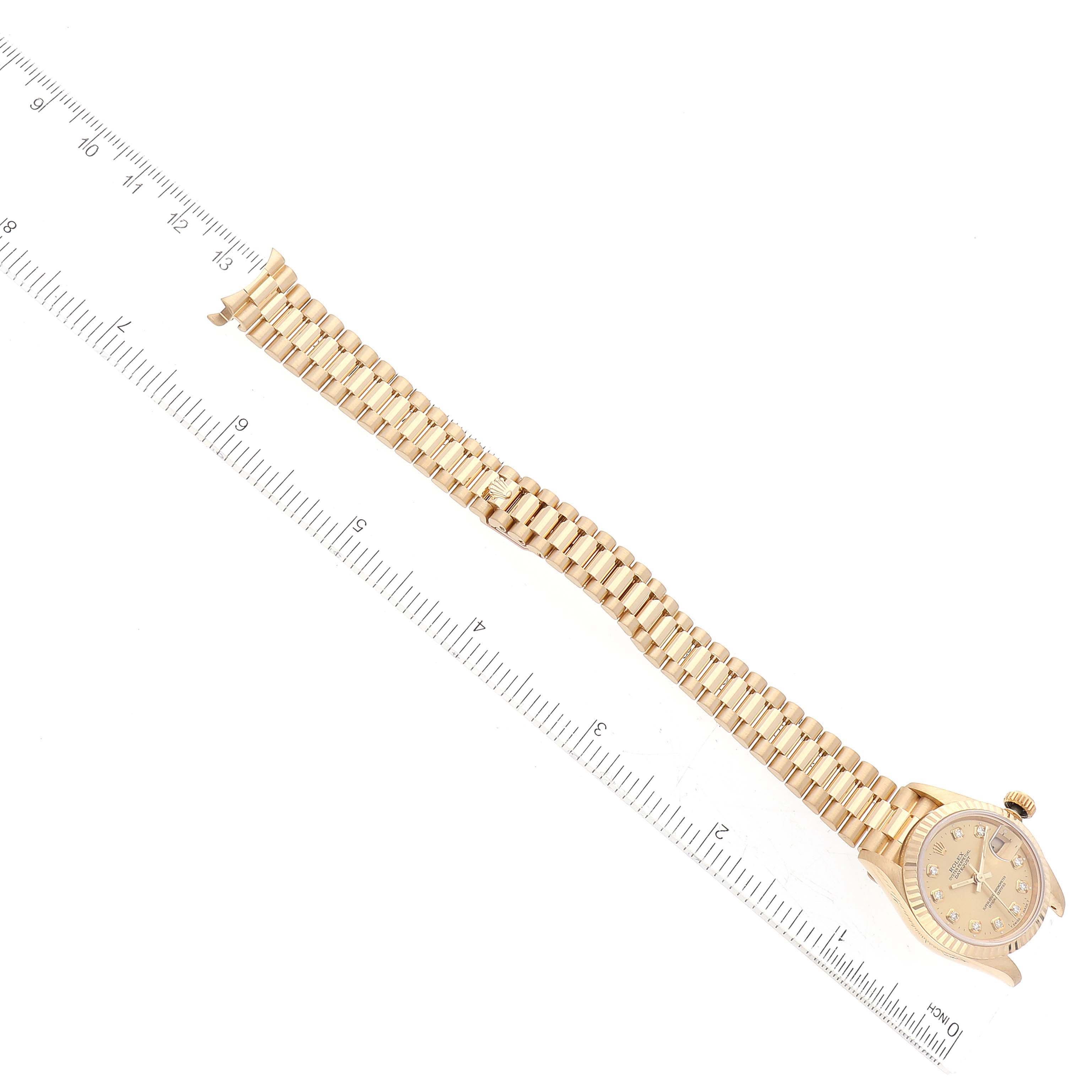 This image shows a Rolex President 69178 Women's Yellow Gold Champagne Dial 69178 Women's Yellow Gold Champagne Dial watch laid flat with the face and bracelet visible, aligned next to a ruler for scale.