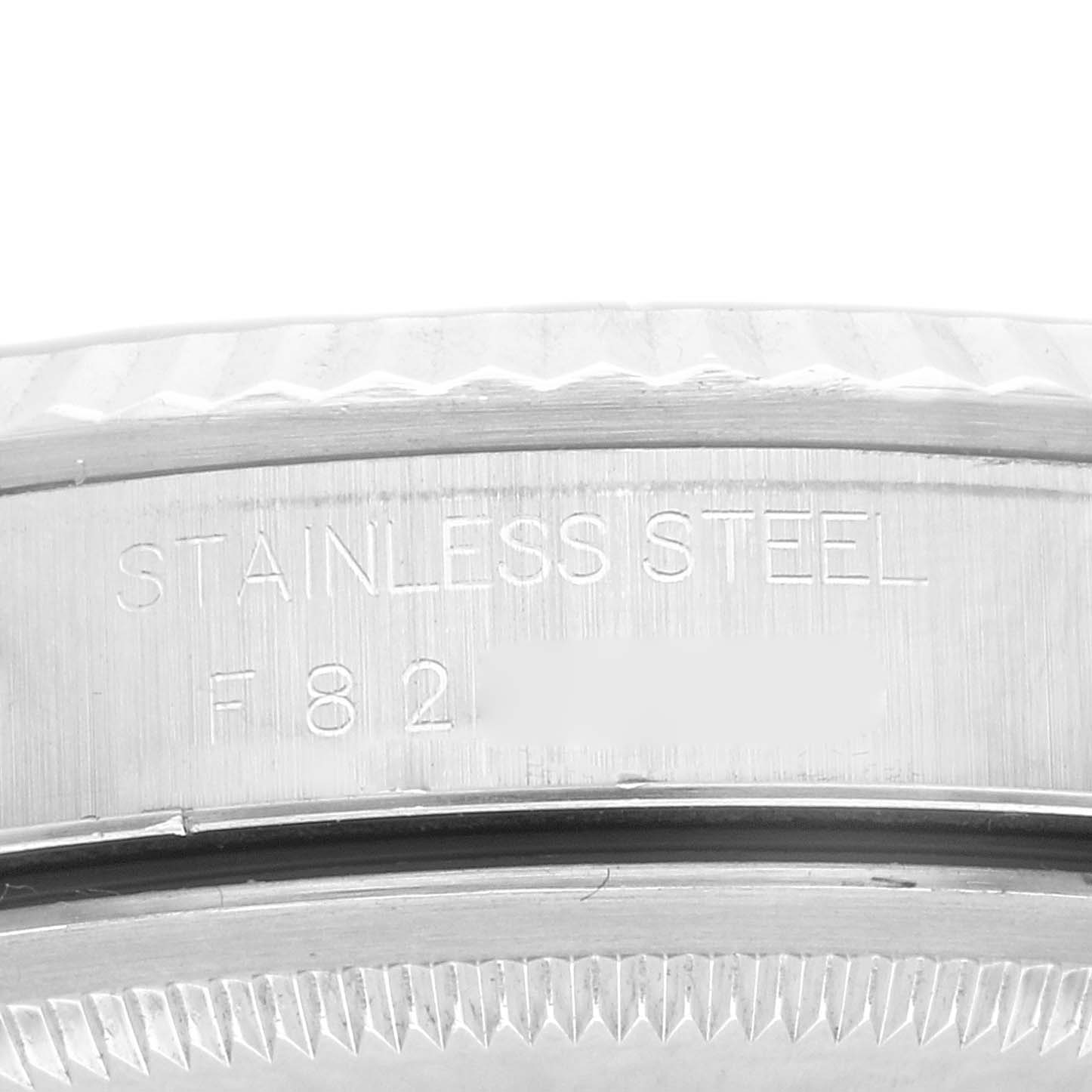 This image shows a close-up of the case back and the outer edge of the bezel of a Datejust model by Rolex, displaying "Stainless Steel" engraving.