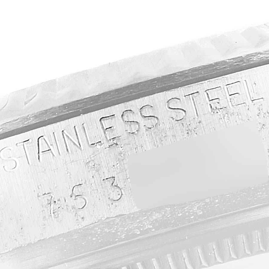 The image shows a close-up of the case side of a Vintage Collection model by Rolex, highlighting the "STAINLESS STEEL" engraving.