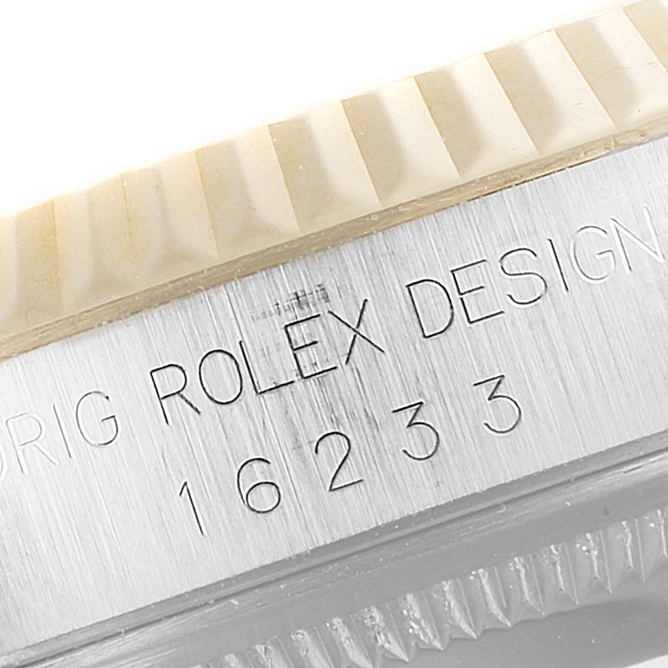 Close-up of the case side of the Rolex Datejust 16233 Men's Steel and Gold (two tone) Blue Dial 16233 Men's Steel and Gold (two tone) Blue Dial watch showing the fluted bezel and engraved model number 16233.