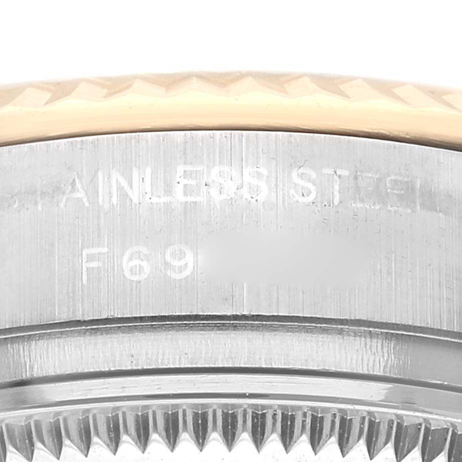 This image shows a close-up of the side of the bezel and case of a Rolex Datejust 179173 Women's Steel and Gold (two tone) Champagne Dial 179173 Women's Steel and Gold (two tone) Champagne Dial, highlighting its stainless steel and model number.