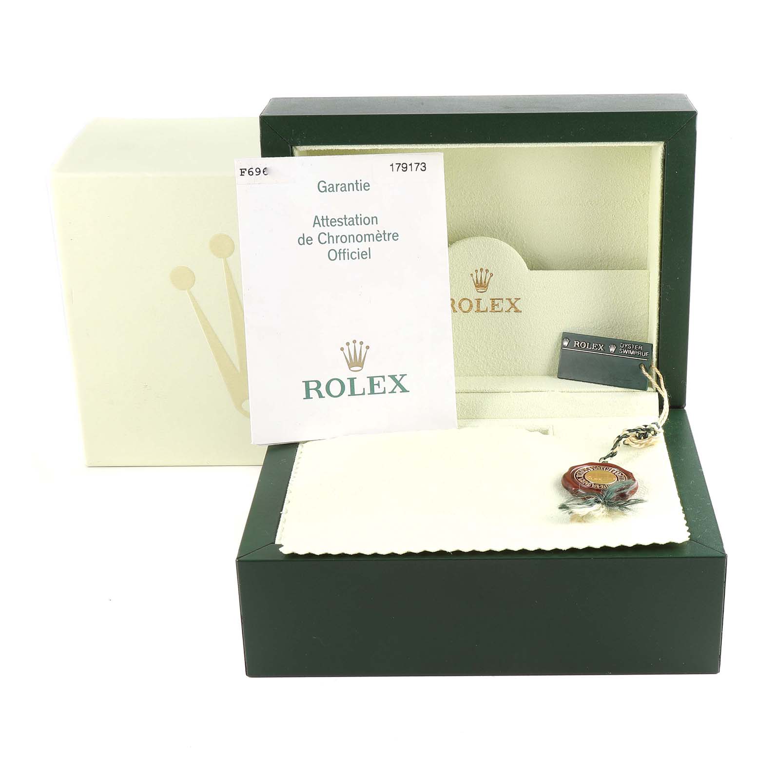 This image shows the packaging, warranty card, and accessories for a Rolex Datejust 179173 Women's Steel and Gold (two tone) Champagne Dial 179173 Women's Steel and Gold (two tone) Champagne Dial watch.