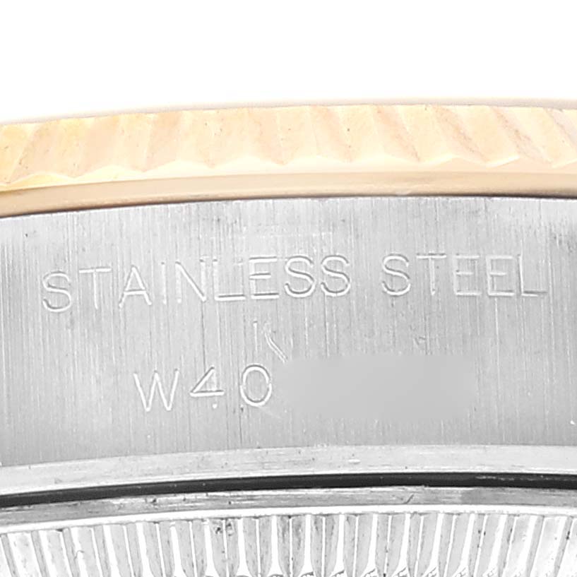This is a close-up angle of the stainless steel back case and the fluted bezel of a Rolex Datejust 69173 Women's Steel and Gold (two tone) Champagne Dial 69173 Women's Steel and Gold (two tone) Champagne Dial watch.