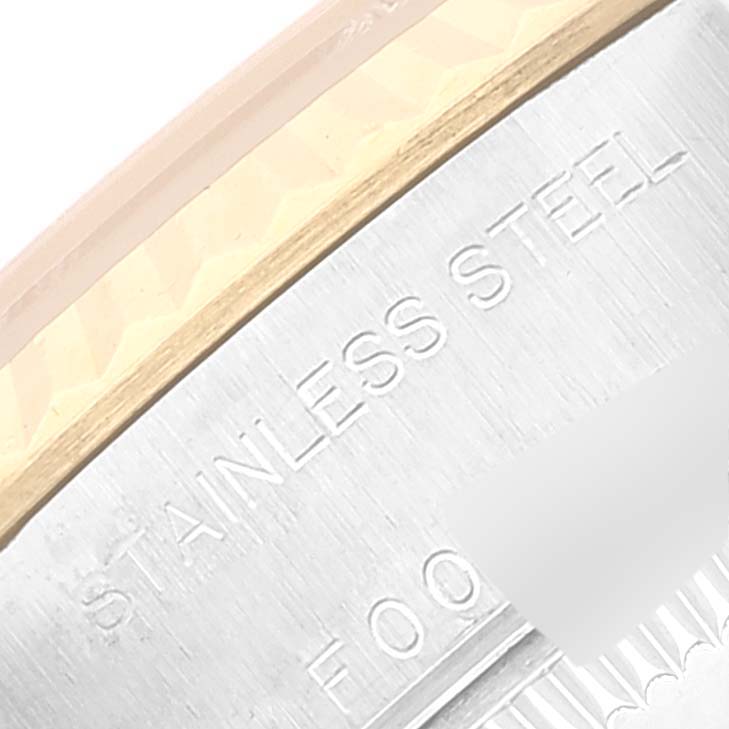 The image shows a close-up of the side case and bezel of a Rolex Datejust 79173 Women's Steel and Gold (two tone) Beige Dial 79173 Women's Steel and Gold (two tone) Beige Dial watch with "Stainless Steel" engraved.