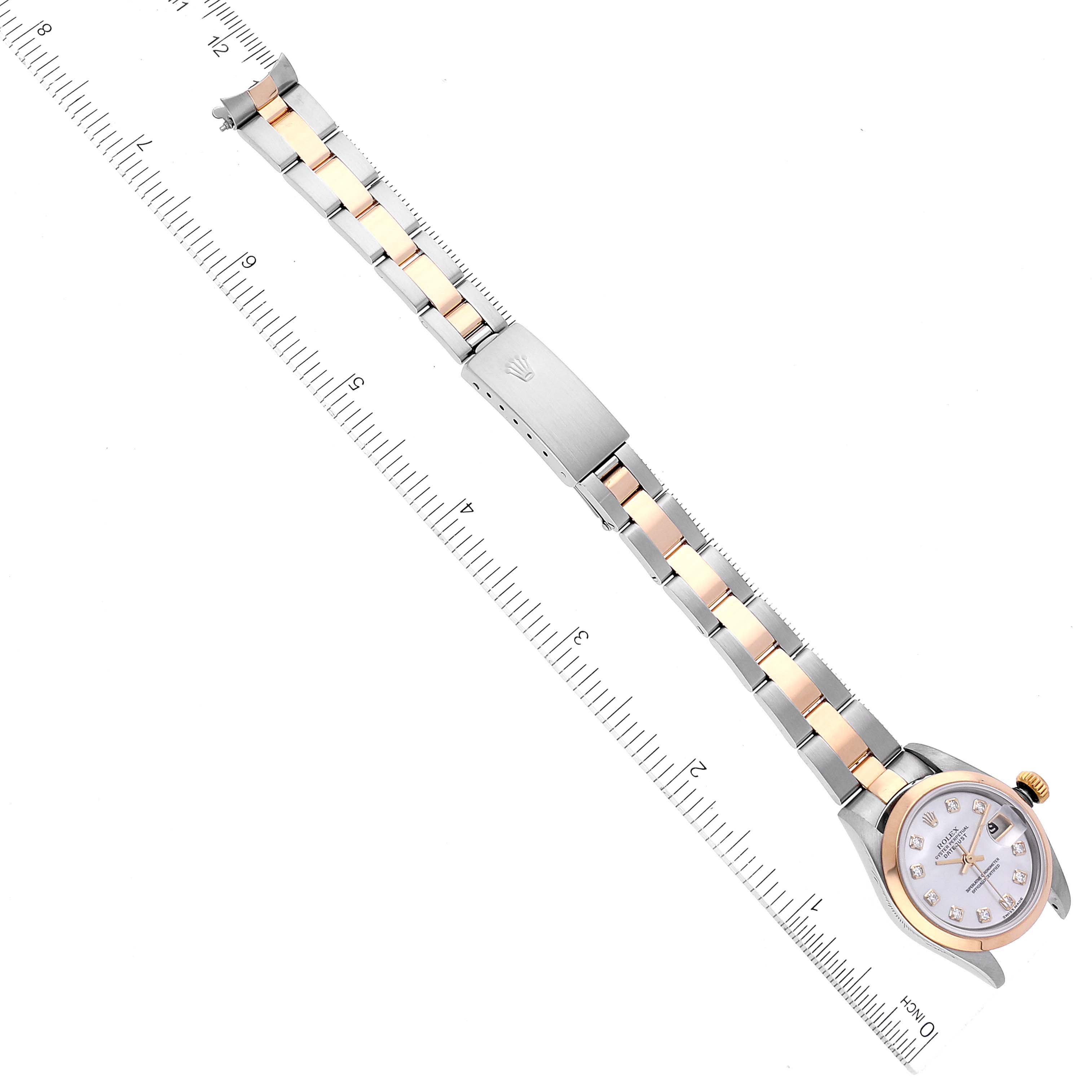The image shows a Rolex Datejust 79163 Women's Steel and Gold (two tone) Mother of Pearl Dial 79163 Women's Steel and Gold (two tone) Mother of Pearl Dial watch laid out flat next to a ruler, displaying the watch face, bracelet, and clasp.