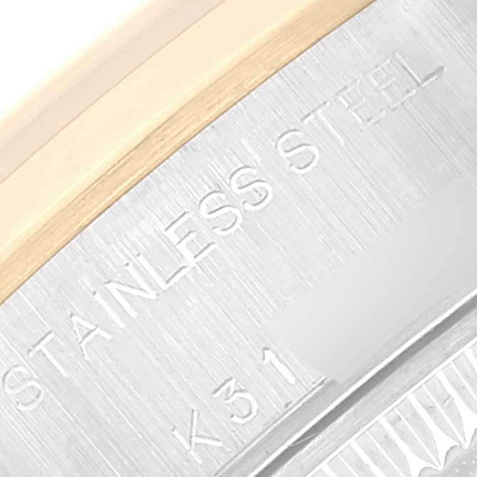 This close-up image of a Rolex Datejust 79163 Women's Steel and Gold (two tone) Mother of Pearl Dial 79163 Women's Steel and Gold (two tone) Mother of Pearl Dial shows part of the stainless steel case with engraved text.