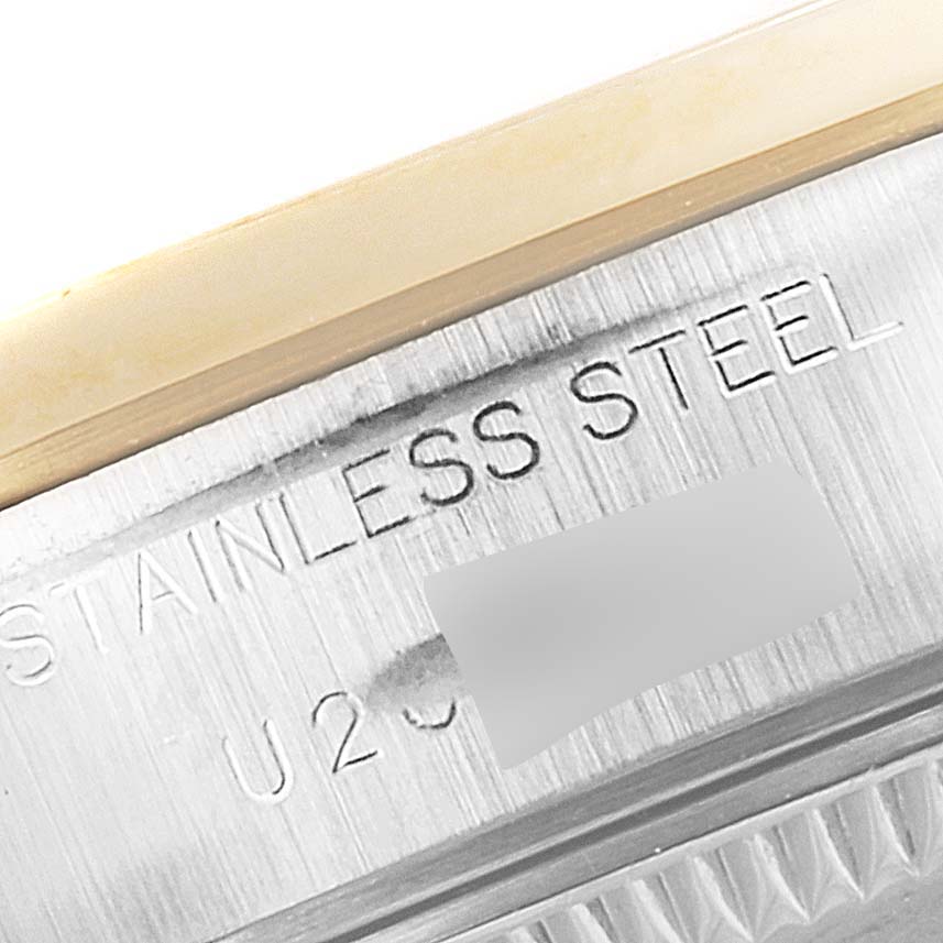 This close-up image shows the side of a Rolex Datejust 69163 Women's Steel and Gold (two tone) White Dial 69163 Women's Steel and Gold (two tone) White Dial watch, revealing the engraving "STAINLESS STEEL" and a partial serial number.