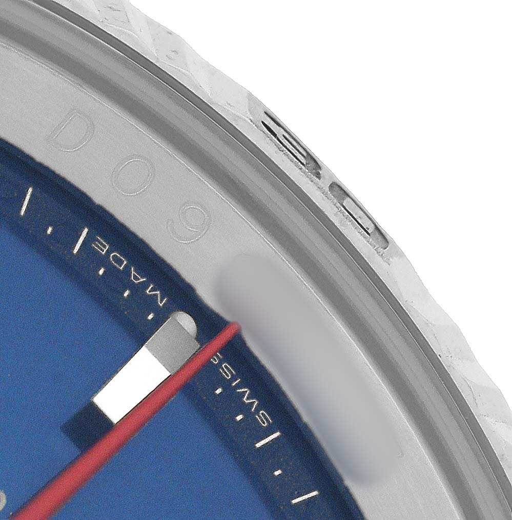 The image shows a close-up of the Rolex Turn-o-Graph 116264 Men's Stainless Steel Blue Dial watch's bezel and dial edge, highlighting the blue dial and red hand.