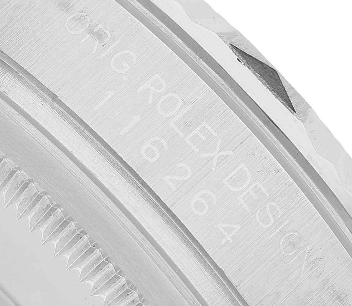 The image shows a close-up of the bezel and engraving on a Rolex Turn-o-Graph 116264 Men's Stainless Steel Blue Dial watch.