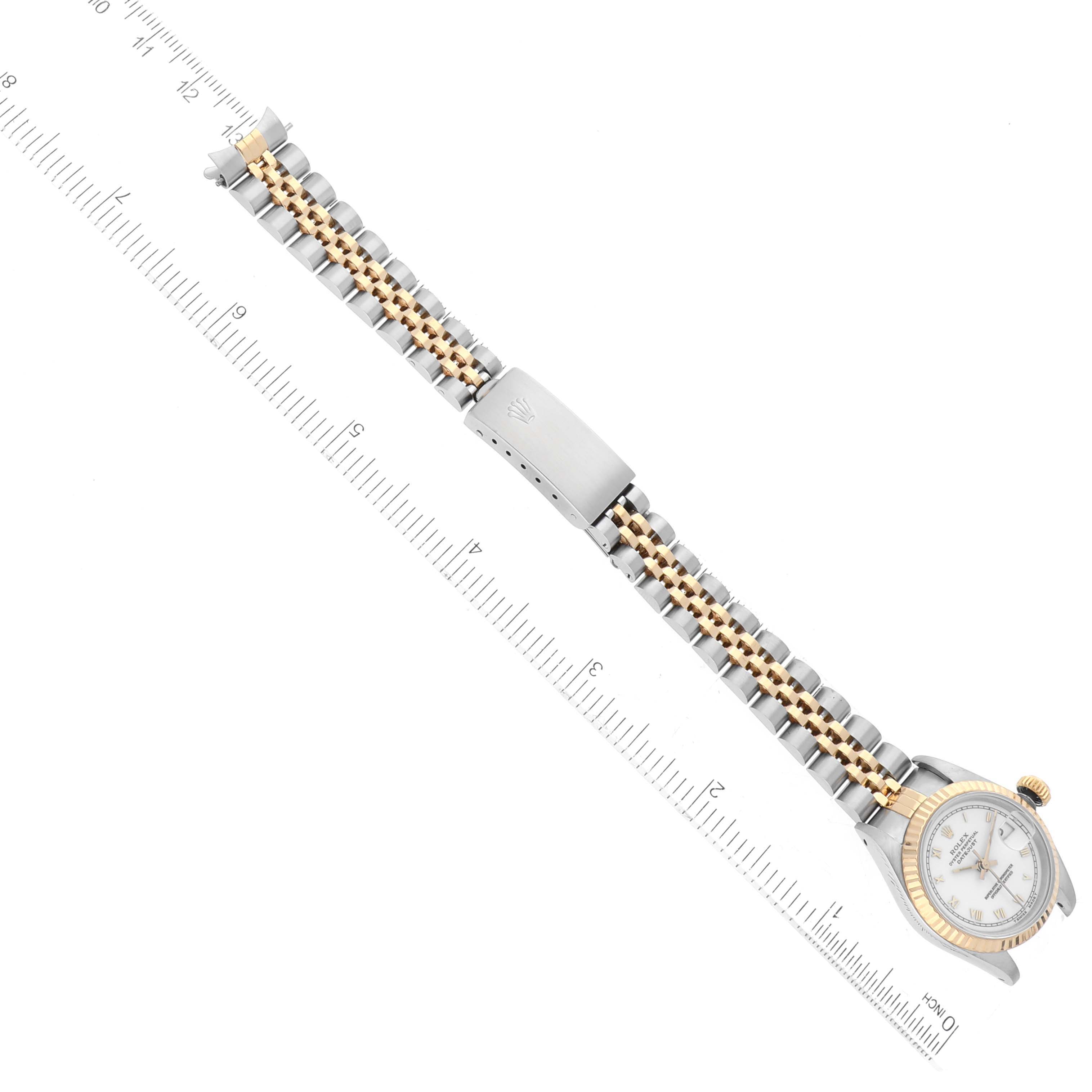 The image shows a top-down view of a Rolex Datejust 69173 Women's Steel and Gold (two tone) White Dial 69173 Women's Steel and Gold (two tone) White Dial watch focusing on the band and clasp with a ruler for scale.