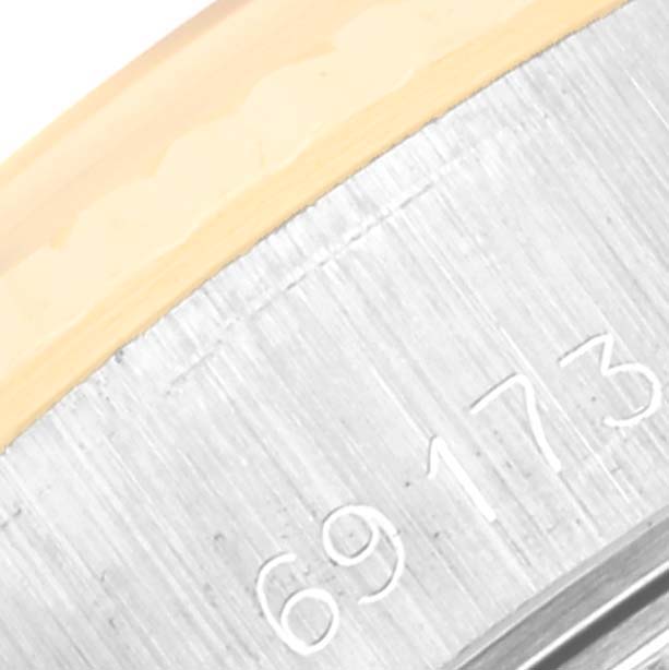 This close-up image shows the model number engraving on the case of a Rolex Datejust 69173 Women's Steel and Gold (two tone) White Dial 69173 Women's Steel and Gold (two tone) White Dial watch.