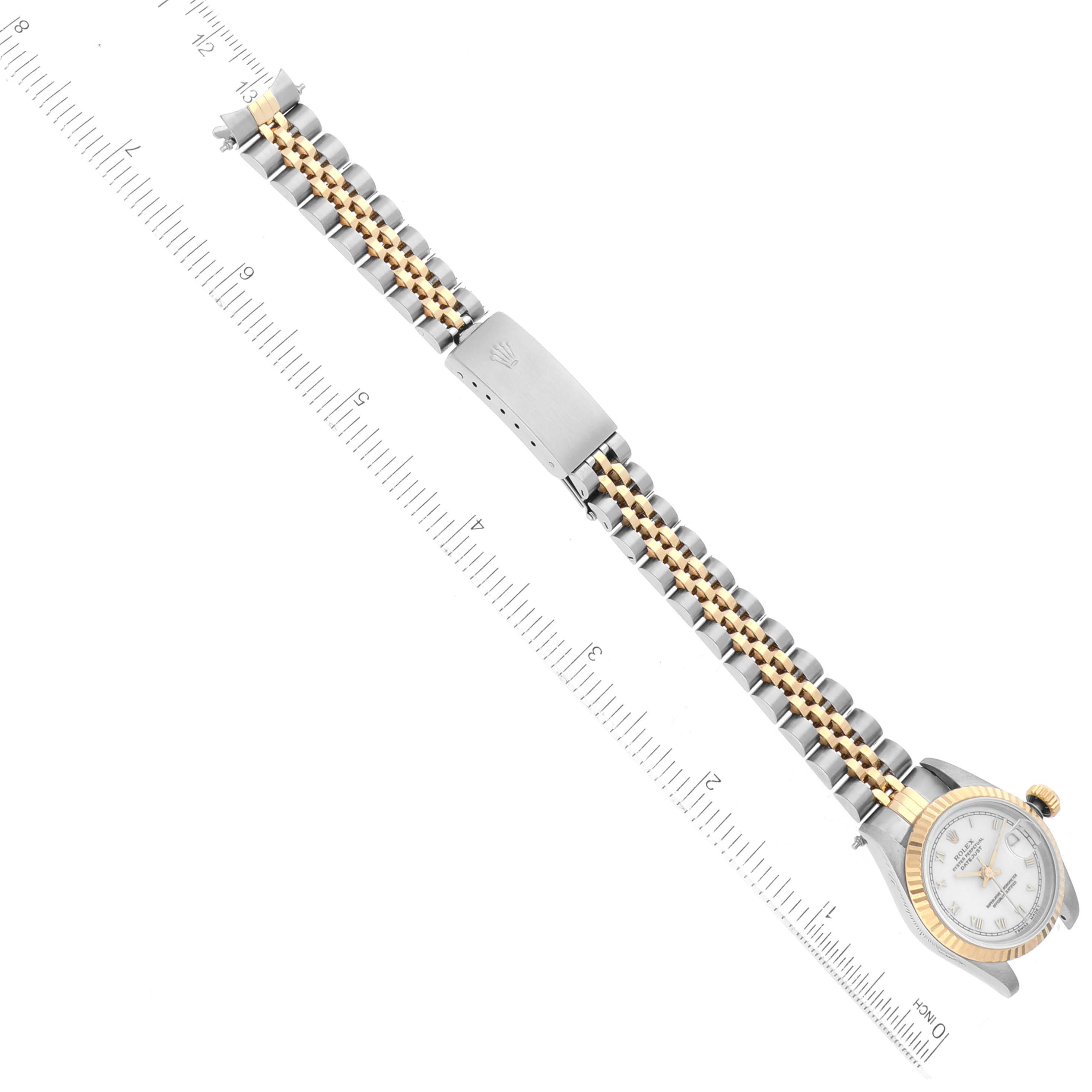 The image shows the Rolex Datejust 69173 Women's Steel and Gold (two tone) White Dial 69173 Women's Steel and Gold (two tone) White Dial watch laid flat with its bracelet extended alongside a measuring ruler.