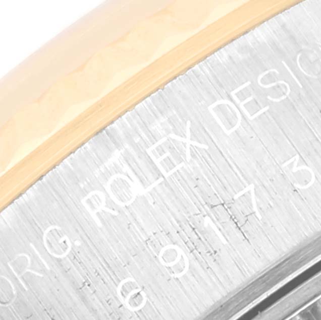 This image shows a close-up of the engraved text on the case back of a Rolex Datejust 69173 Women's Steel and Gold (two tone) White Dial 69173 Women's Steel and Gold (two tone) White Dial watch.