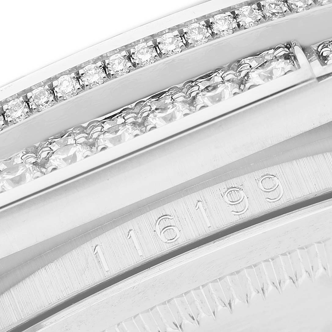 The image shows a close-up angle of the bezel and case side of a Rolex Datejust 116199 SANR Women's White Gold Black Dial, highlighting diamonds and the engraved model number.