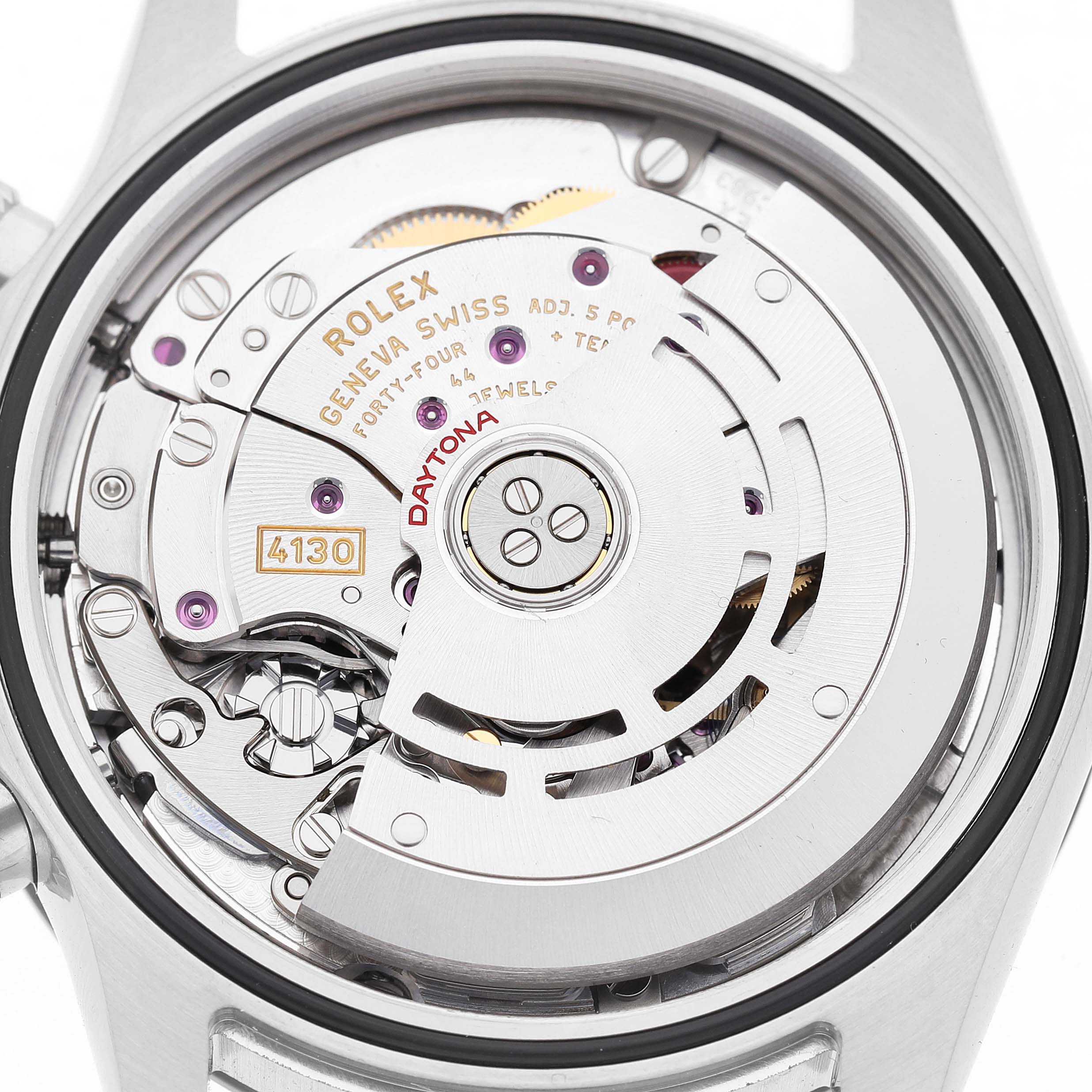 The image shows a close-up view of the Rolex Daytona 116500LN Men's Stainless Steel White Dial's movement, highlighting the intricate mechanics and engraving.