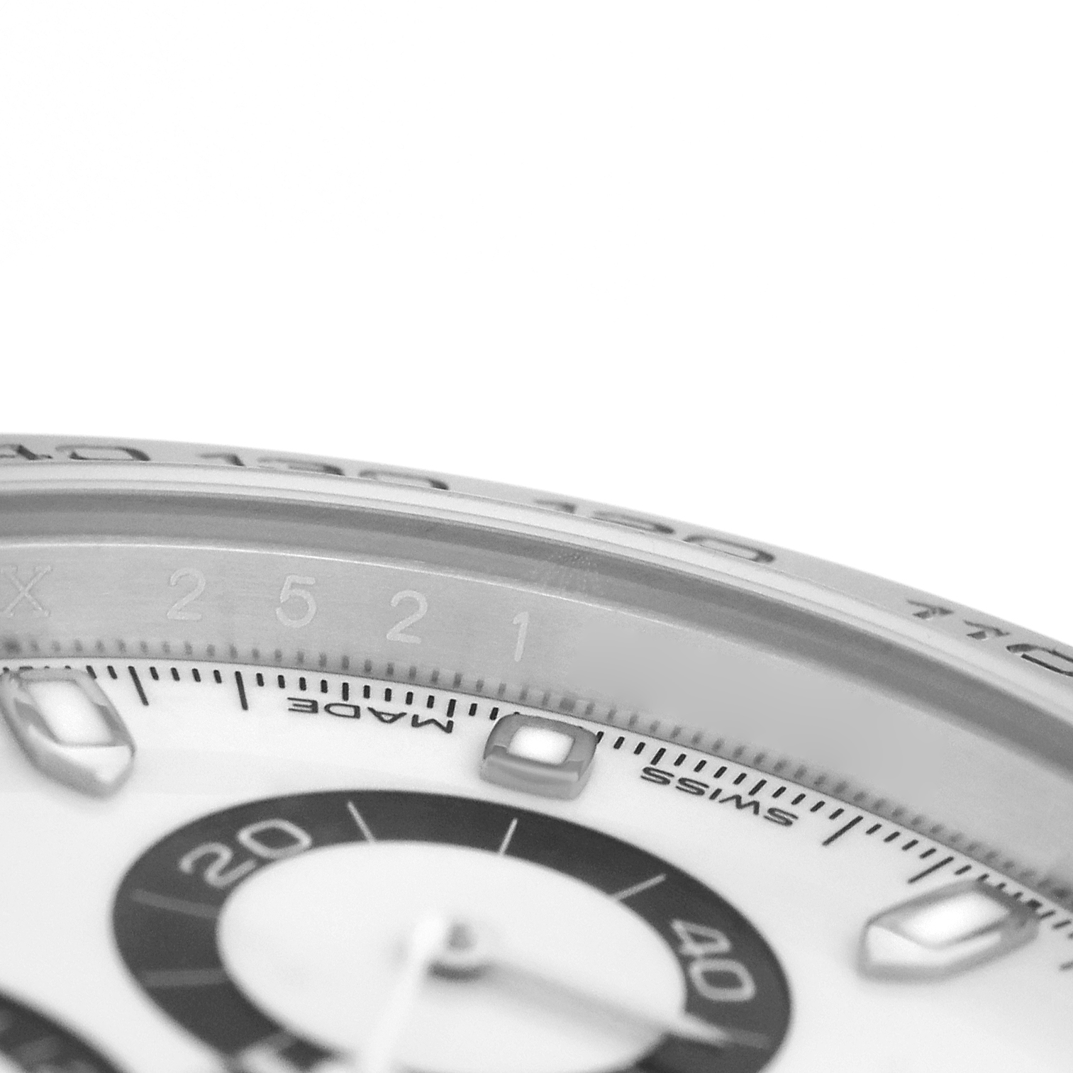 The image shows a close-up of the dial and bezel edge of a Rolex Daytona 116500LN Men's Stainless Steel White Dial, highlighting the subdial and tachymetric scale.