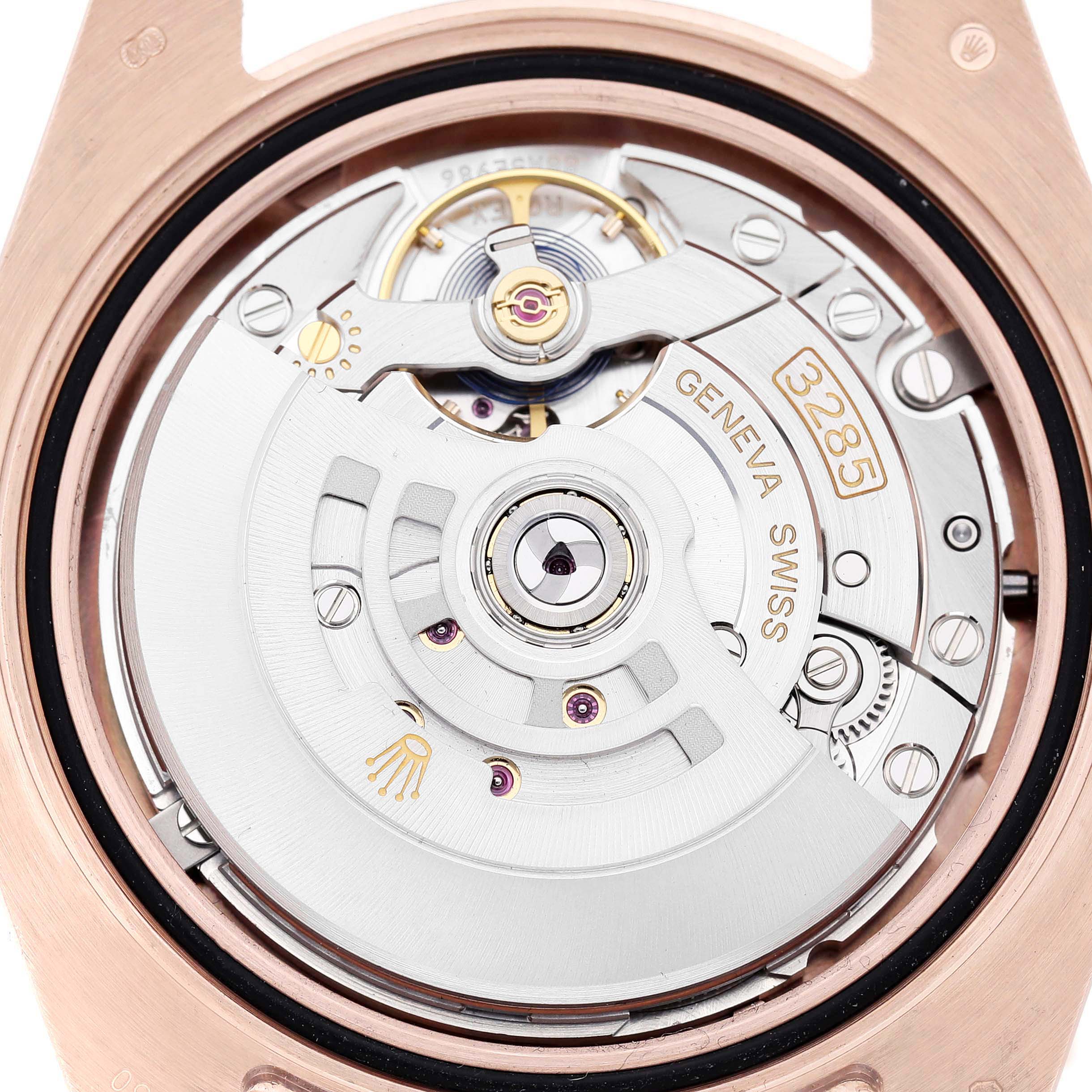 The image shows the movement of a Rolex GMT-Master 126715CHNR Men's Rose Gold Black Dial, focusing on the caliber 3285 with visible gears and components.