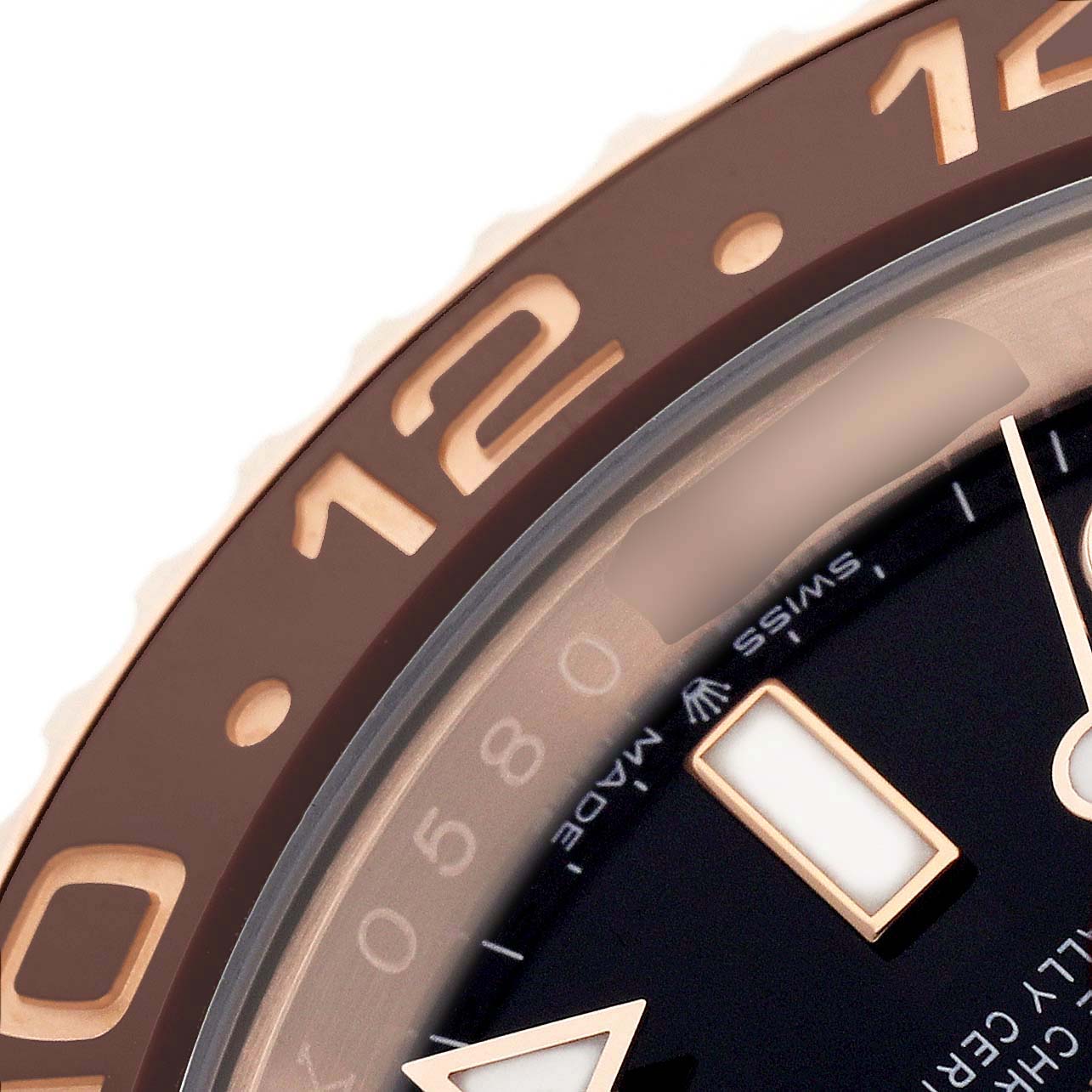 The image shows a close-up of the bezel and hour markers of a Rolex GMT-Master 126715CHNR Men's Rose Gold Black Dial watch at an angle highlighting the 12 and 24-hour scale.
