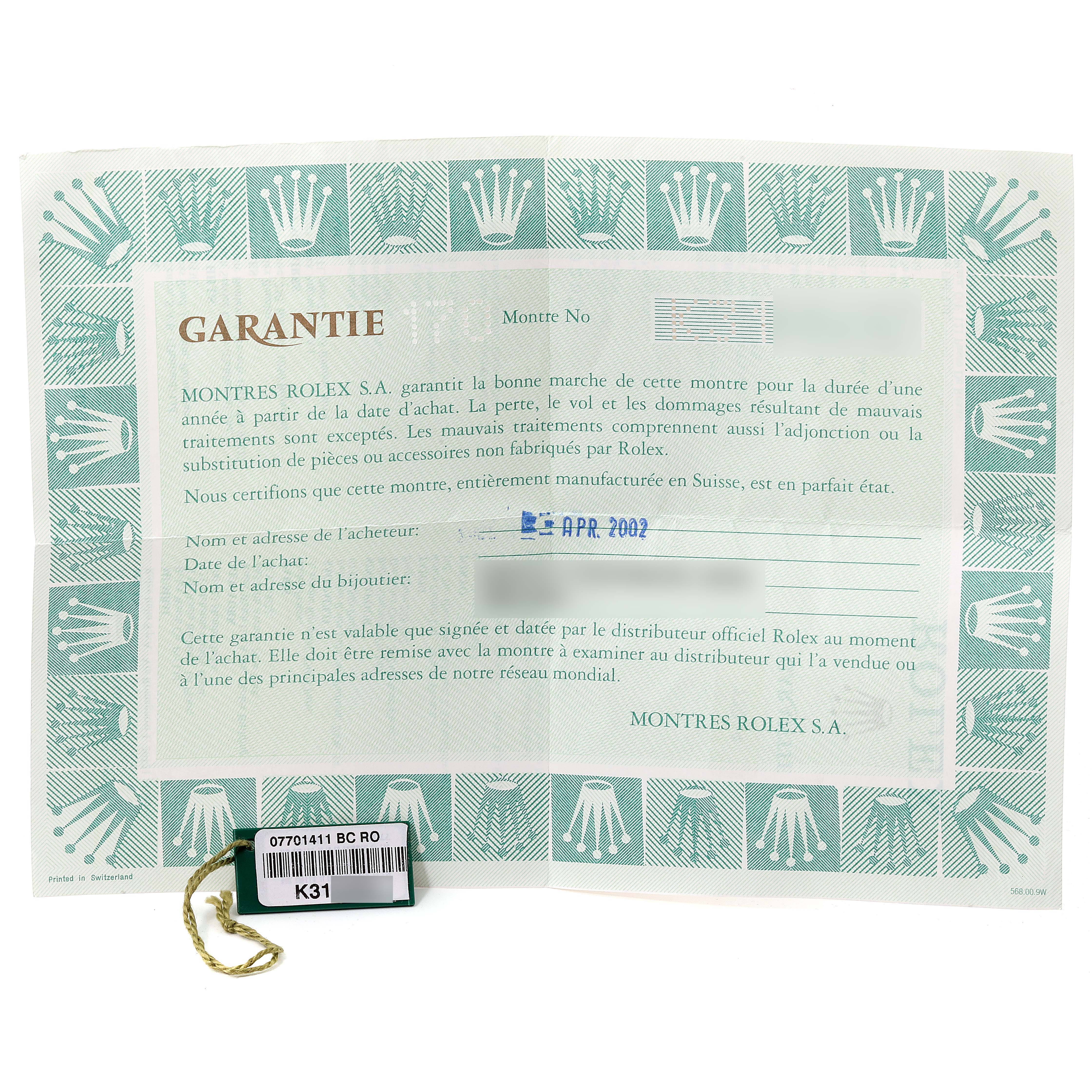 The image shows the warranty card and tag with a serial number for a mid-size Rolex watch.