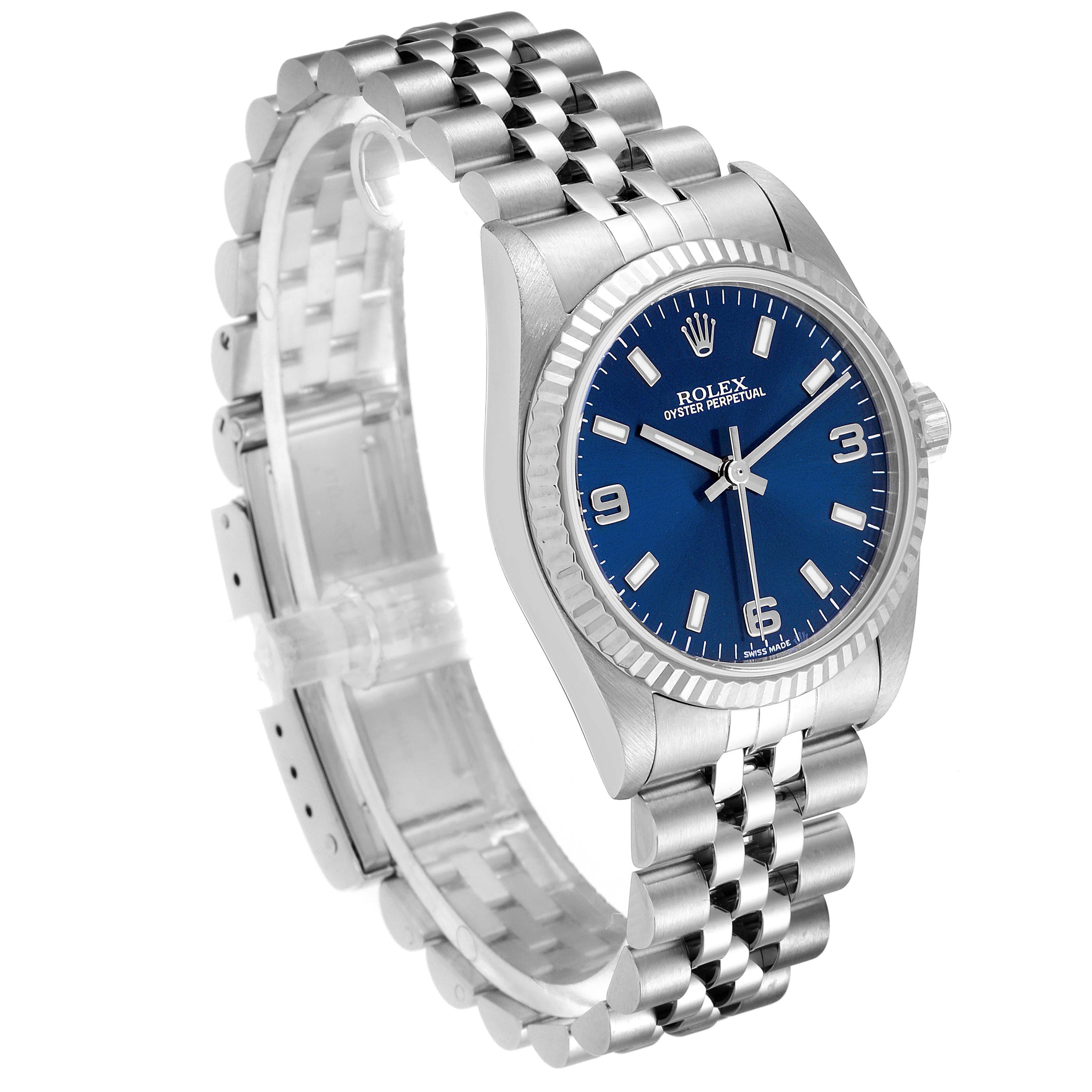 The Rolex Mid-Size 77014 Women
s Stainless Steel Blue Dial 77014 Women
s Stainless Steel Blue Dial watch is shown at a three-quarter angle, displaying the blue dial, bezel, and metal bracelet.