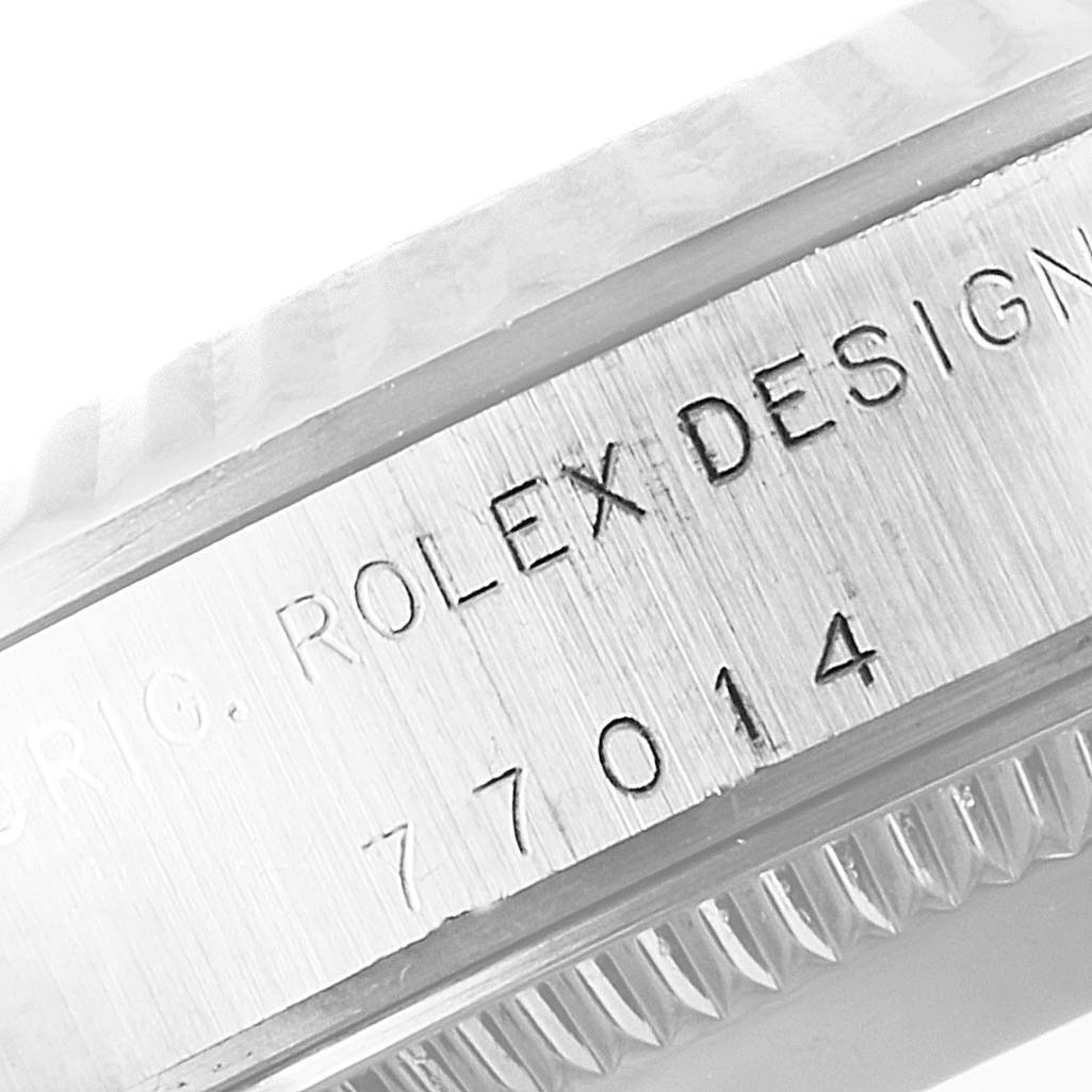 This image shows a close-up view of the serial number engraving on the case of a Rolex Mid-Size 77014 Women
s Stainless Steel Blue Dial 77014 Women
s Stainless Steel Blue Dial model 77014 watch.
