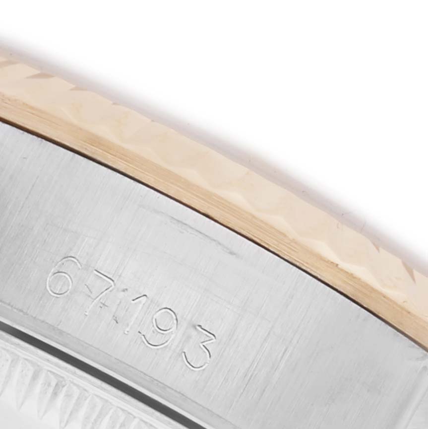 The image shows a close-up of the bezel and part of the case back of a Rolex Oyster Perpetual 67193 Women's Steel and Gold (two tone) Champagne Dial 67193 Women's Steel and Gold (two tone) Champagne Dial, with a visible engraved number.