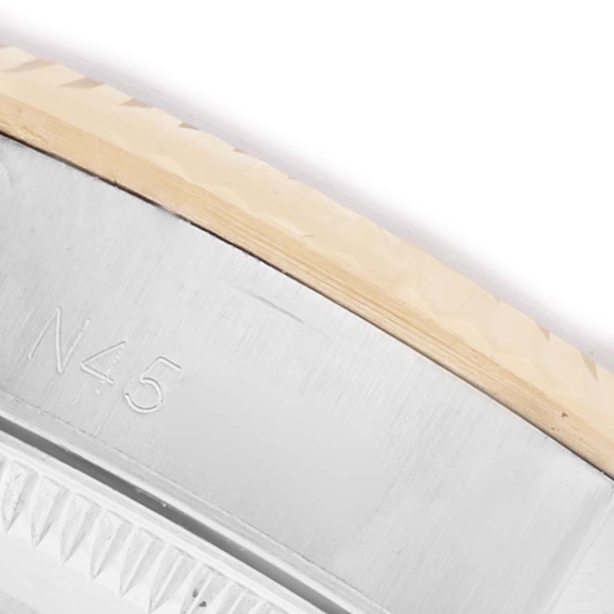 The image shows a close-up of the bezel's edge on a Rolex Oyster Perpetual 67193 Women's Steel and Gold (two tone) Champagne Dial 67193 Women's Steel and Gold (two tone) Champagne Dial watch, displaying part of the rehaut.