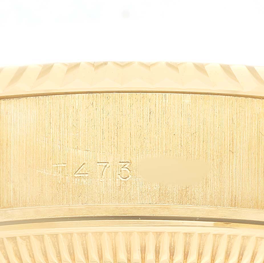 The image shows the side case of a Rolex President 69178 Women's Yellow Gold Champagne Dial model, highlighting its engraving and fluted bezel.