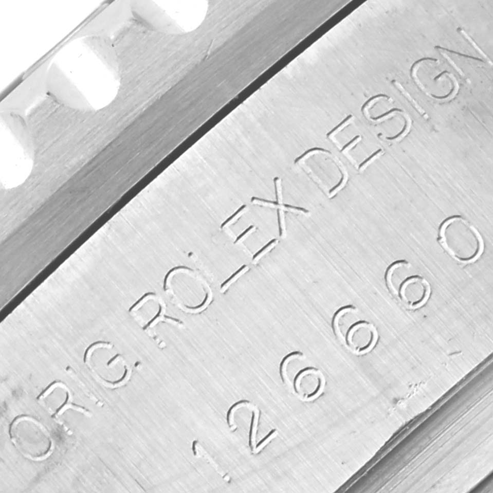 The image shows a close-up of the engraved side of a Rolex Sea-Dweller 126660 Men
s Stainless Steel Blue Dial 126660 Men
s Stainless Steel Blue Dial watch, highlighting the serial number and design details.